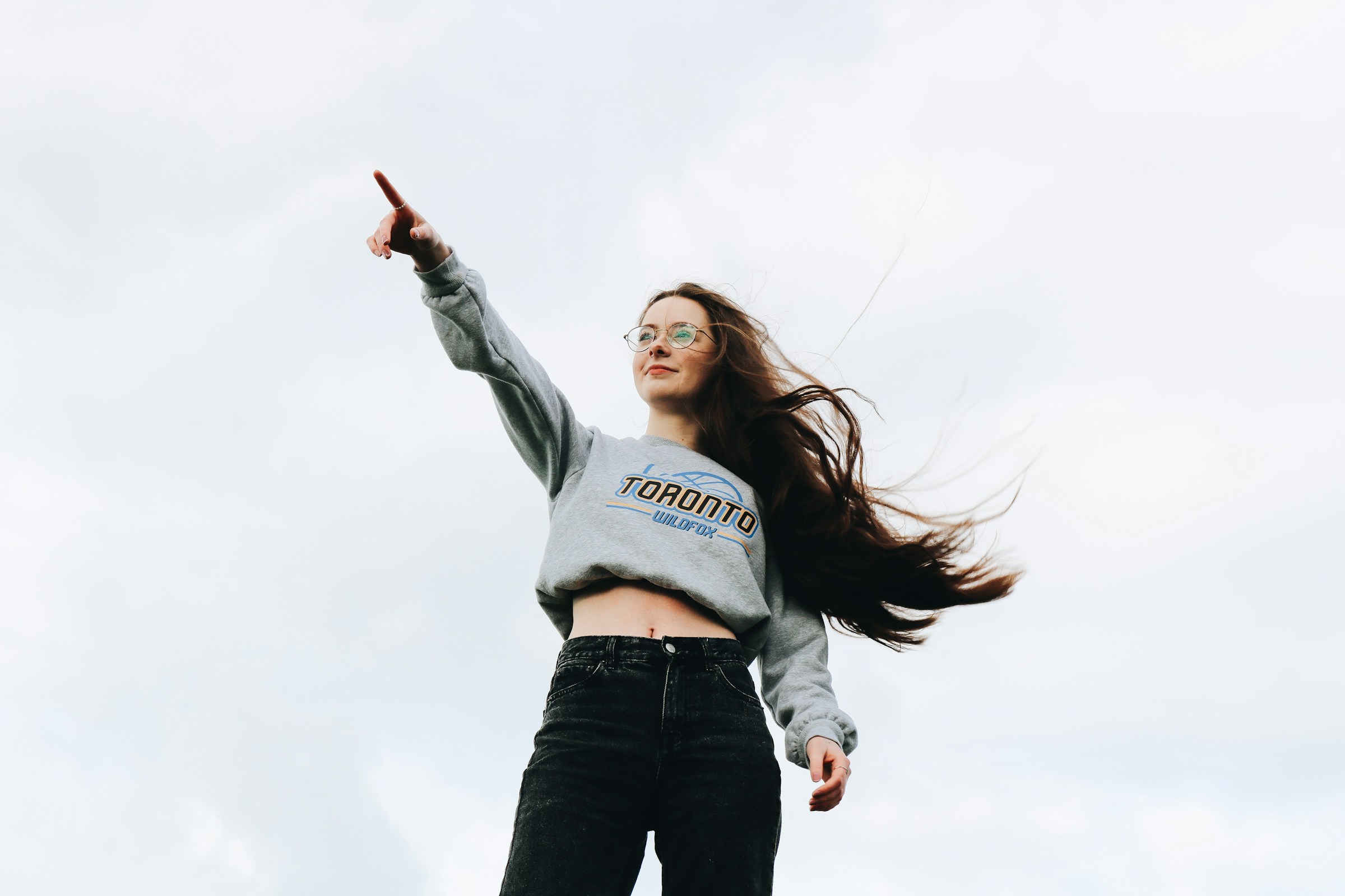 woman pointing at something - Preppy Girl Aesthetic