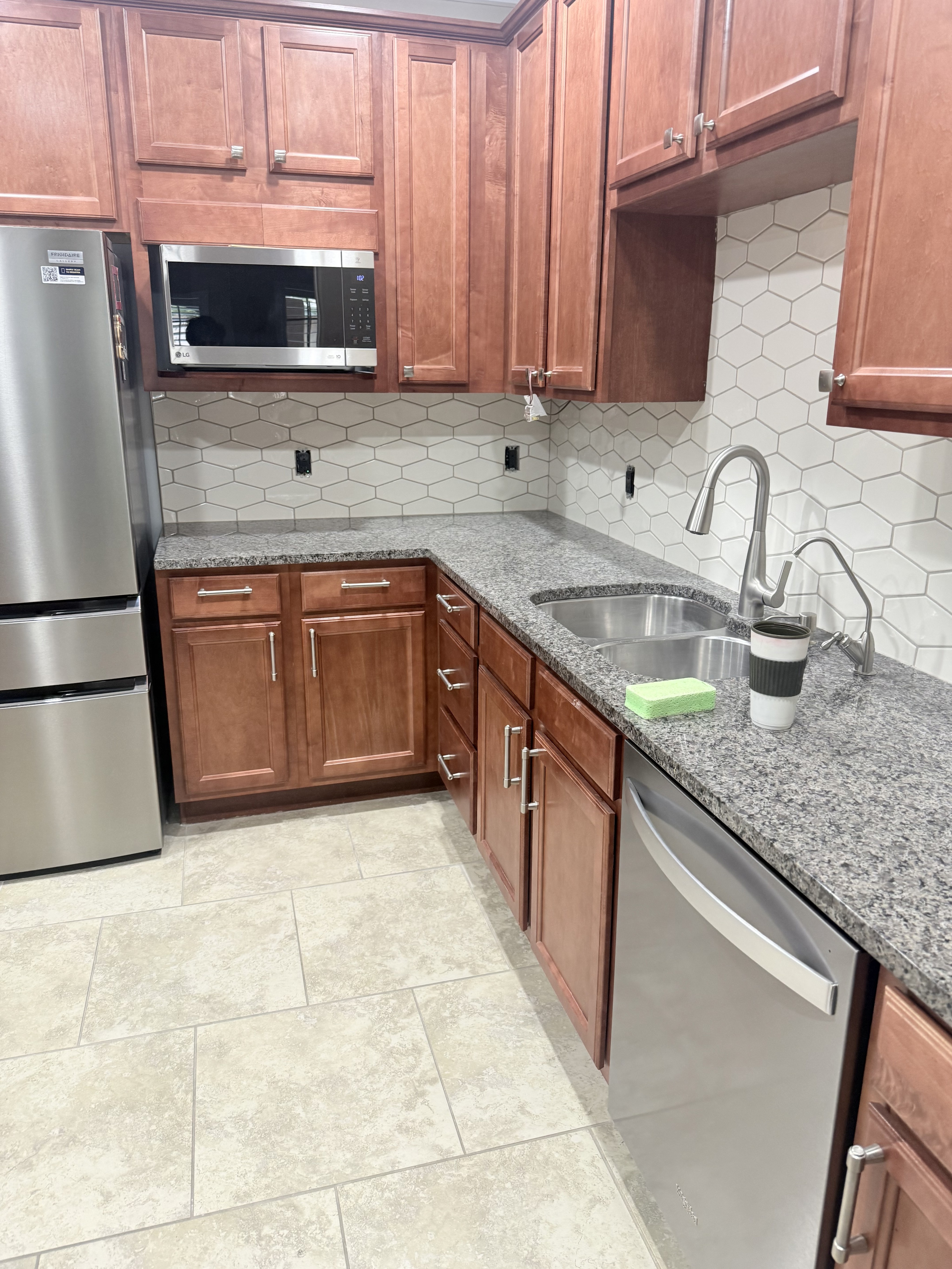 Modern room with a black and white striped tile wall and a window with horizontal blinds.