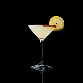 A closeup of a Lemon Drop drink against a dark background.