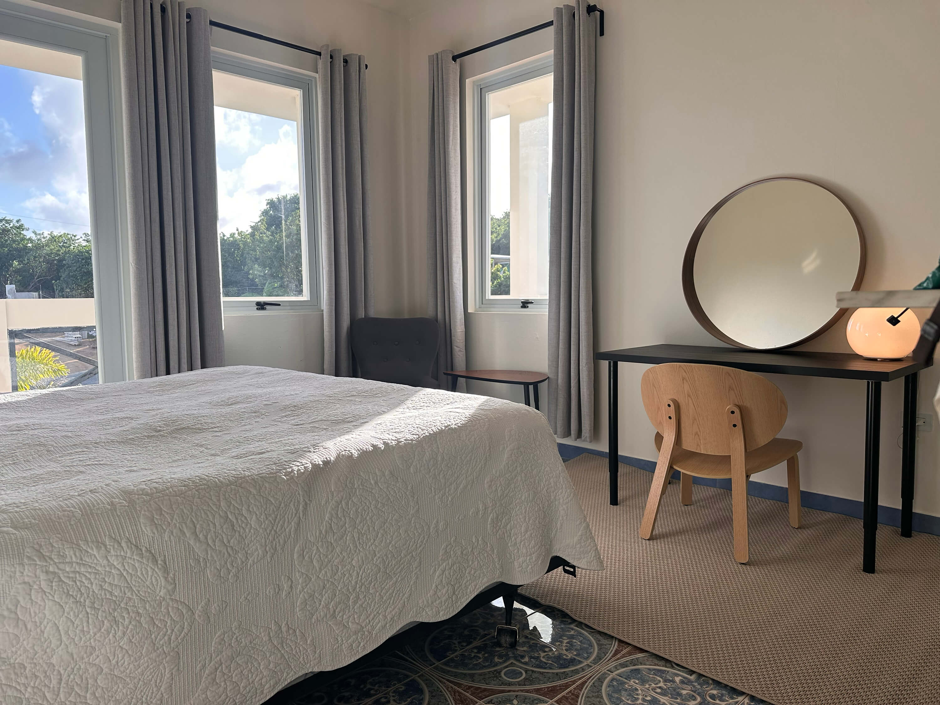 Another angle of the king bed in Room 6 at Club Vieques, highlighting the stylish headboard and lighting.