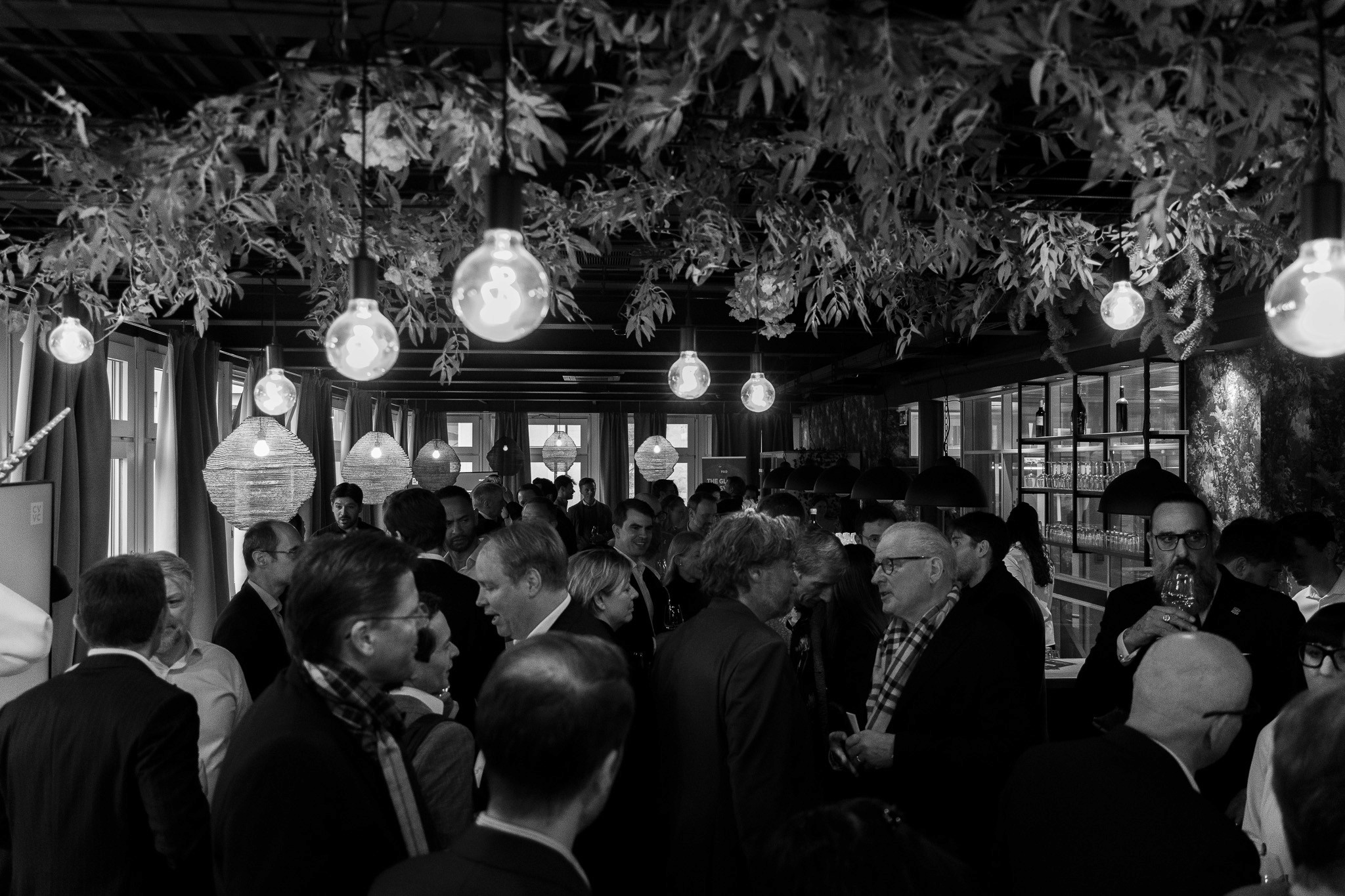 Evening reception with guests networking at a blockchain event.