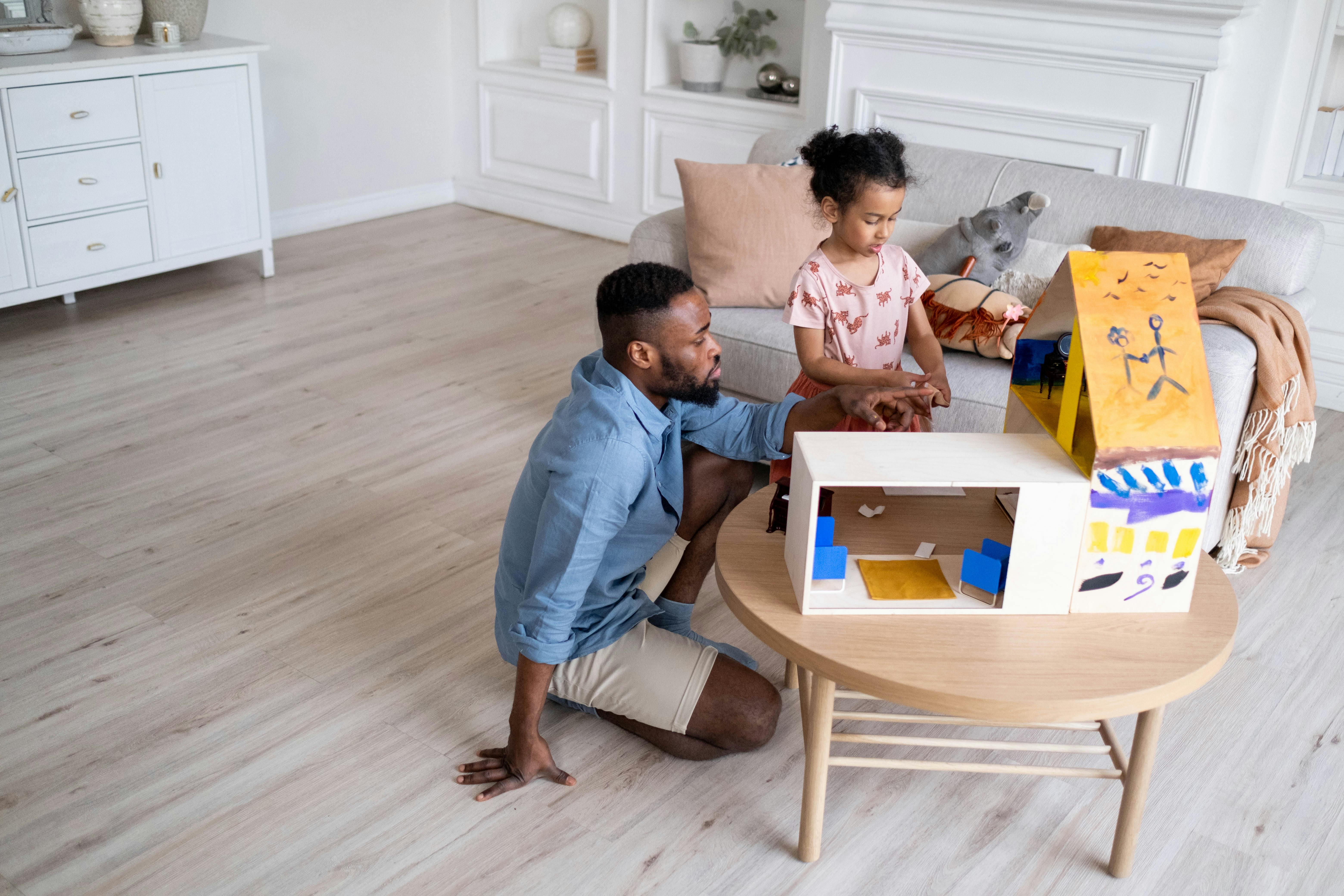 Dad and young child playing on the living room floor in a Brisbane home — family-friendly flooring made for sitting, playing and everyday mess without stress