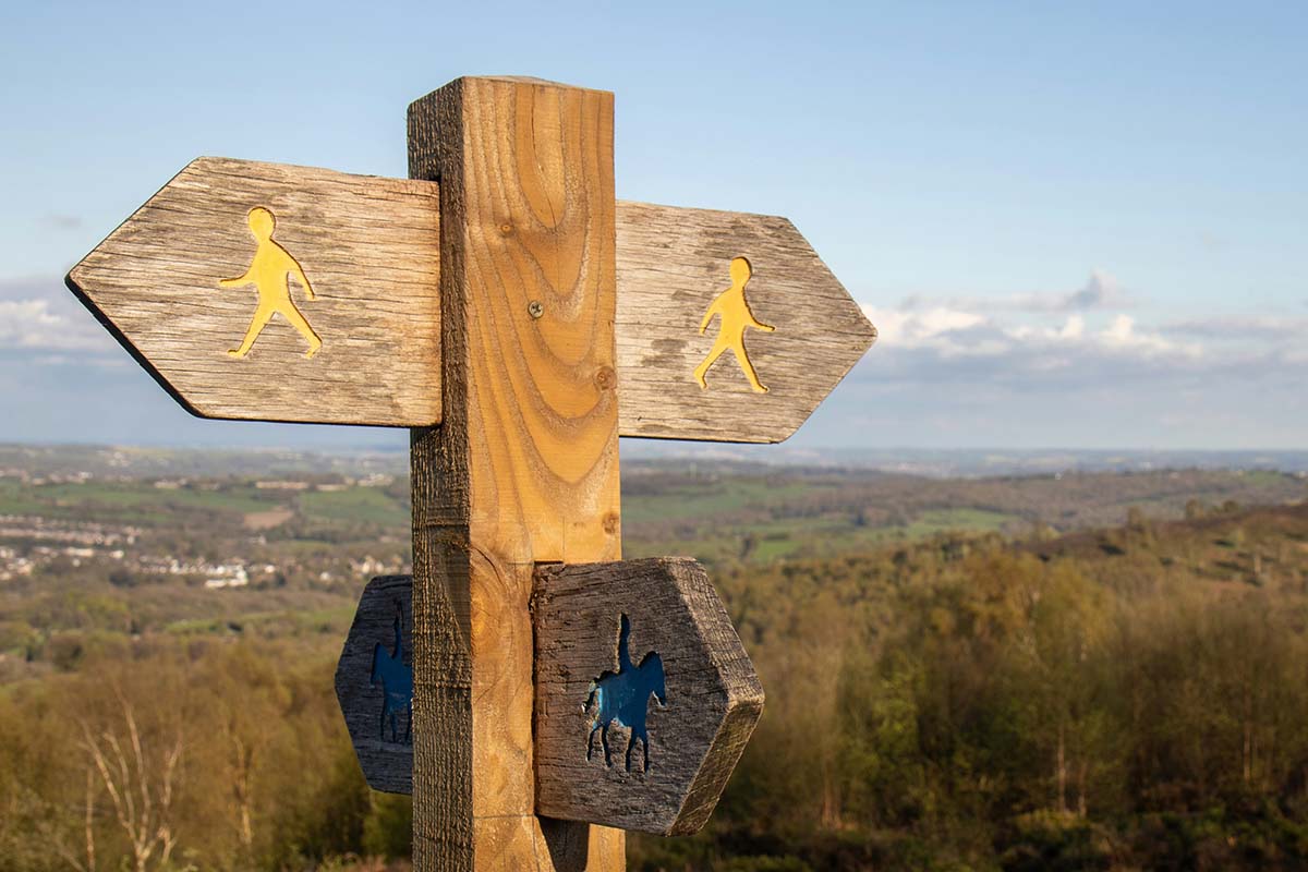 footpath signposts pointing in opposite directions