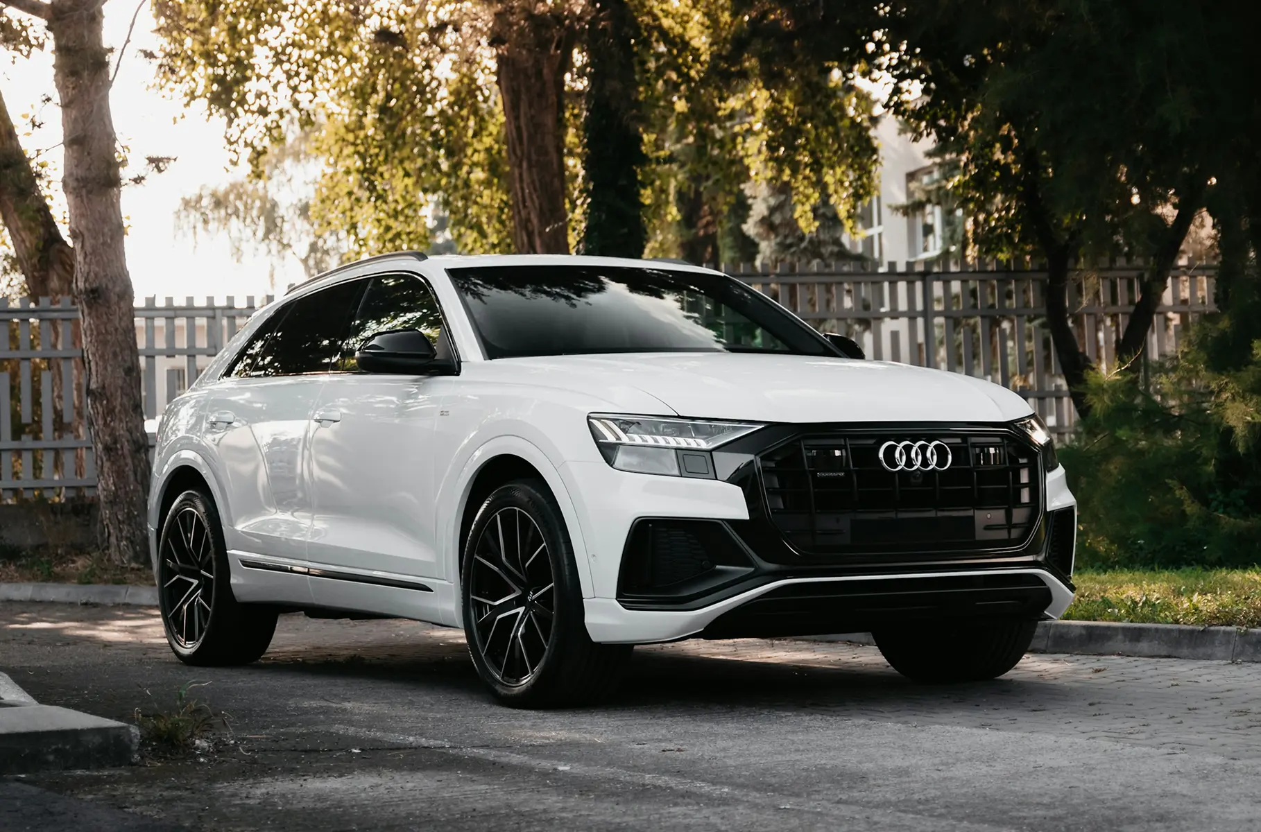 White SUV parked outdoors, representing a modern car rental website used for comparing custom and template website solutions