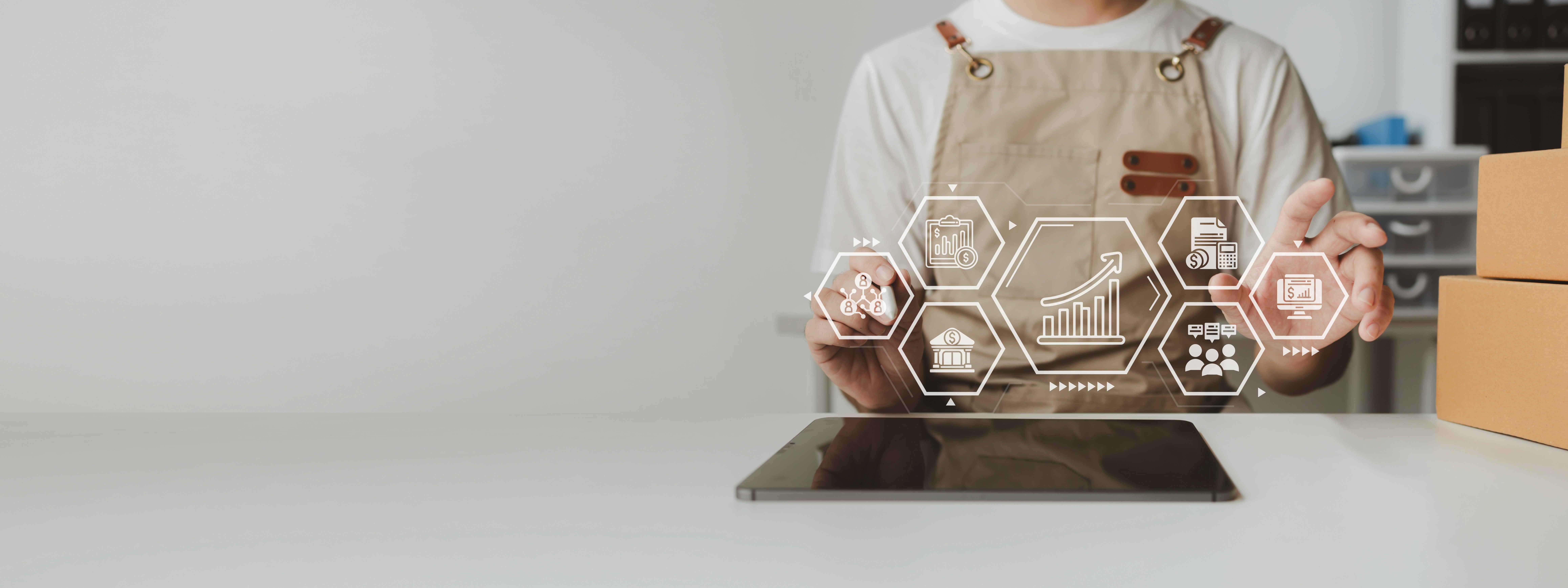a group of people sitting around a table with laptops