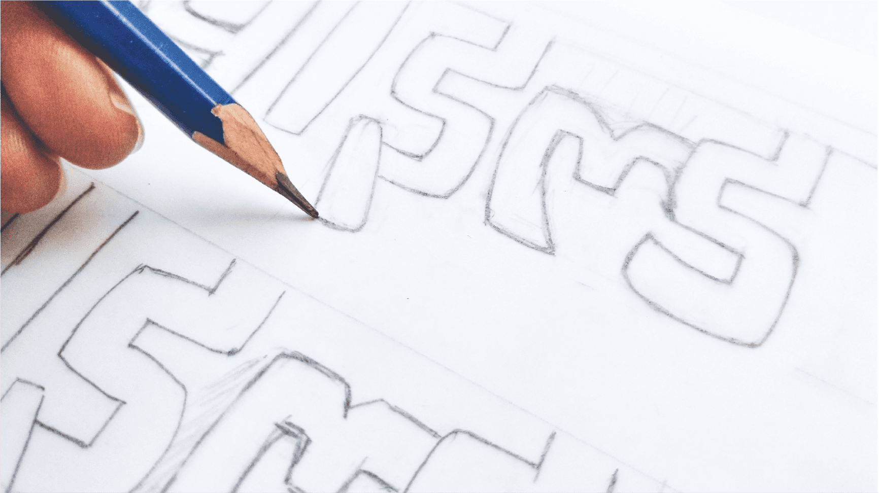 Close-up of a yellow tennis ball sitting on a green court, positioned near the white center line.