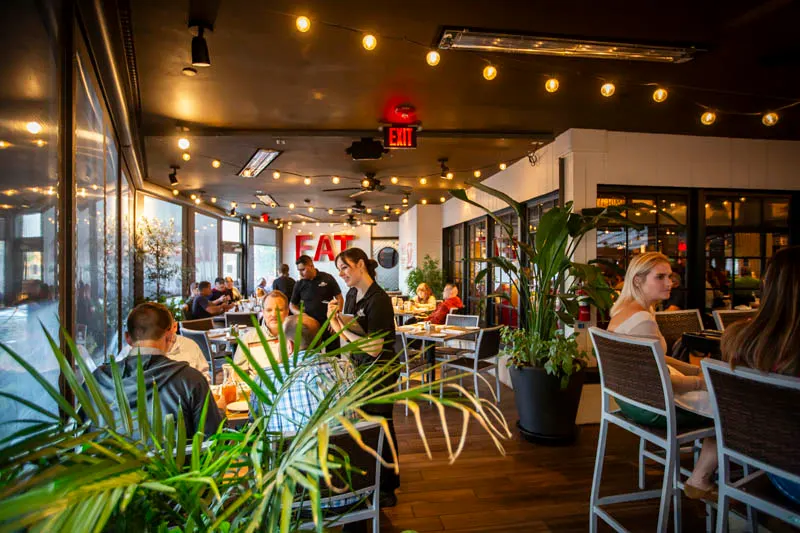 Dining room with string lights and plants at Cap City Grandview