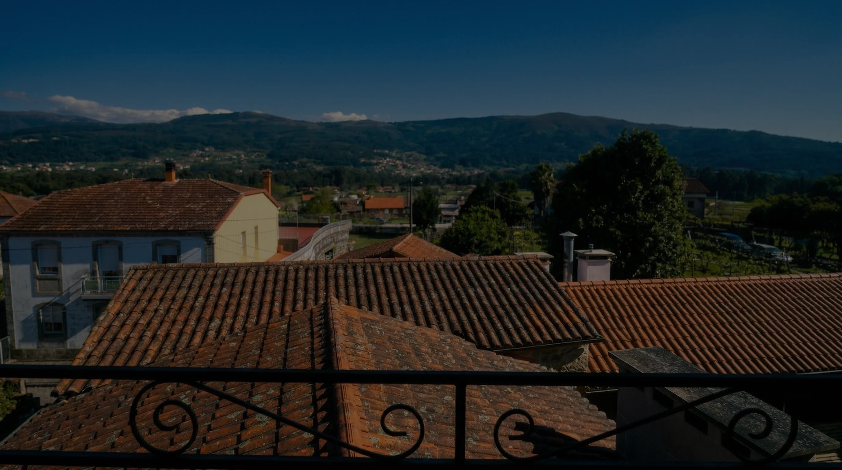 Vistas panorámicas desde Casa Cruceiro hacia los tejados y viñedos de Arbo