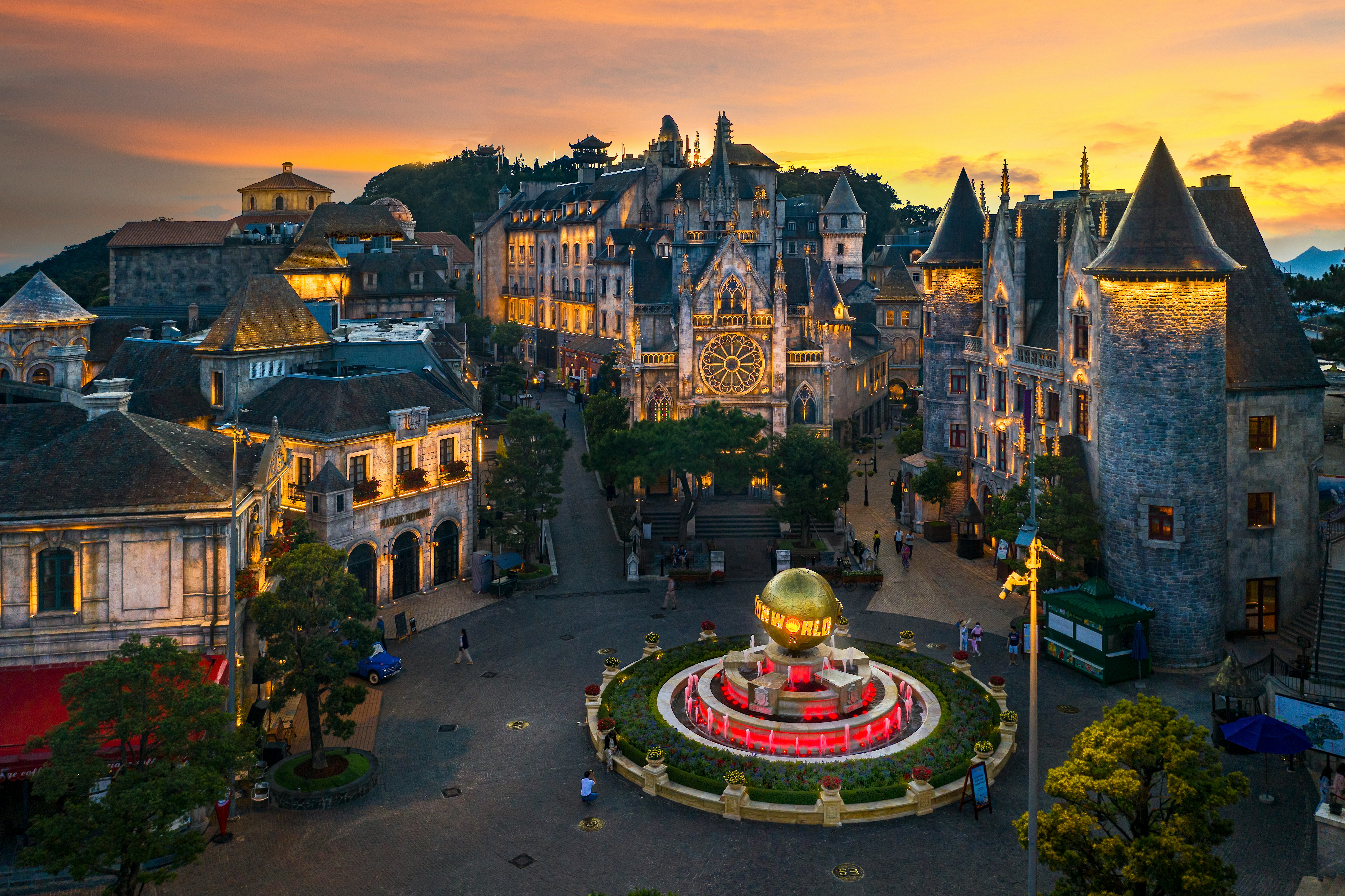 an aerial view of a city with a fountain