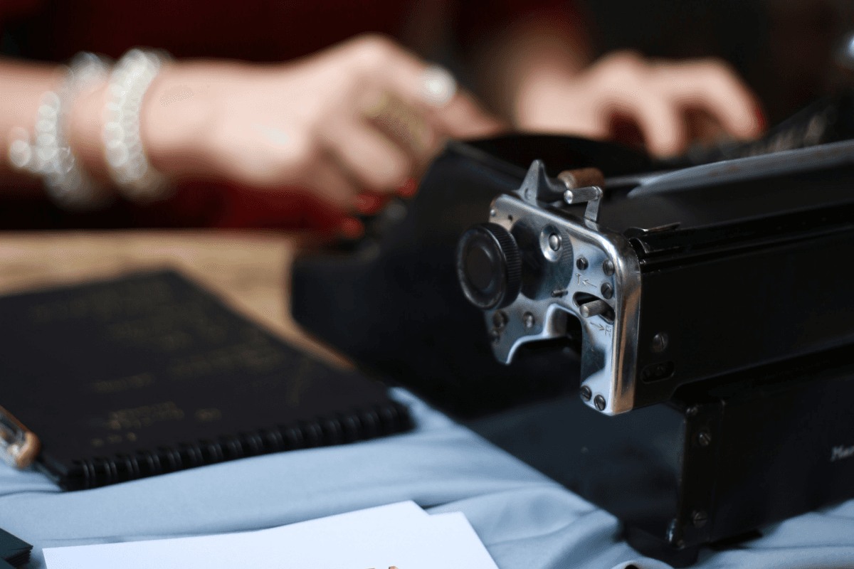 womans hands typing on a vintage typingmachine