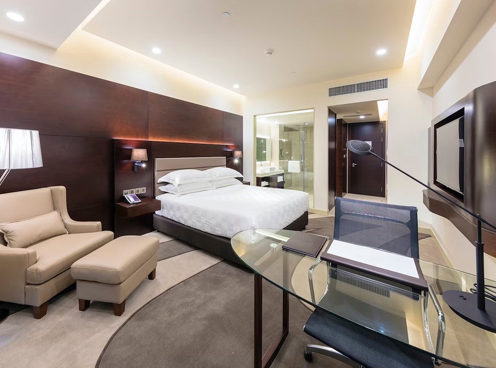 a woman in a red cape standing in the woods