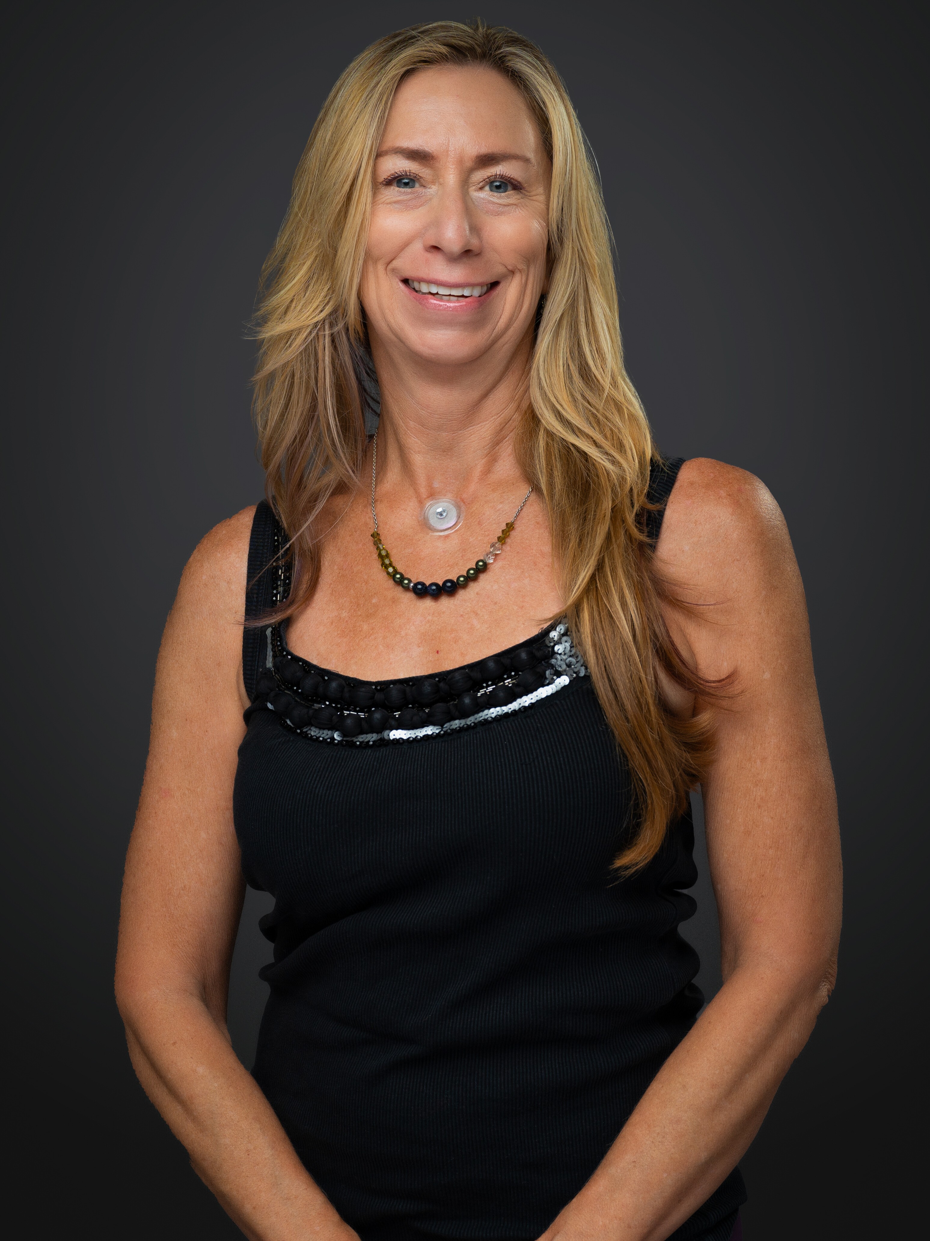 Experienced physical therapist posing confidently in a bright, welcoming treatment space.