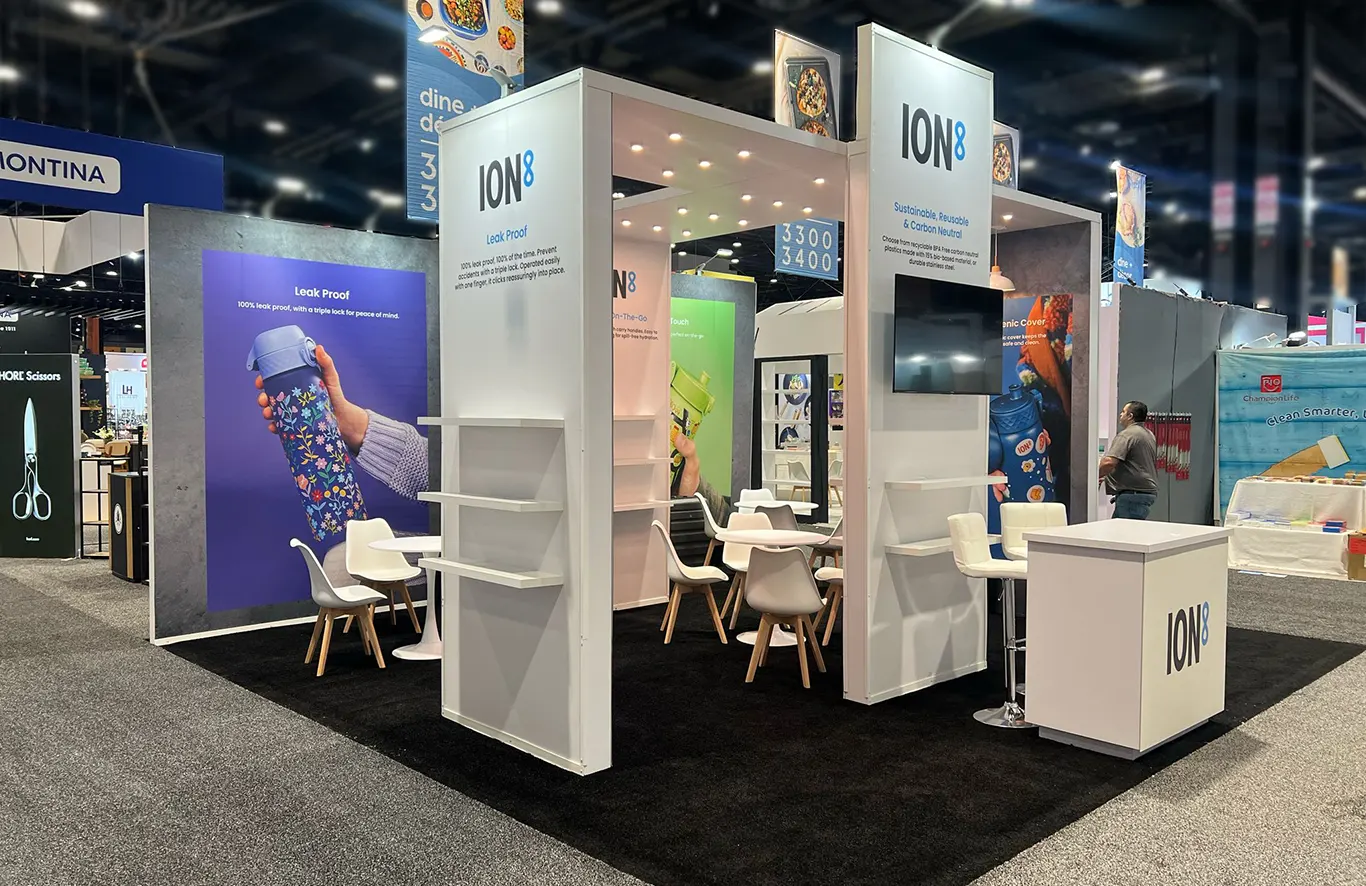 Retail-style housewares trade show booth at The Inspired Home Show Chicago featuring clean product displays and structured shelving