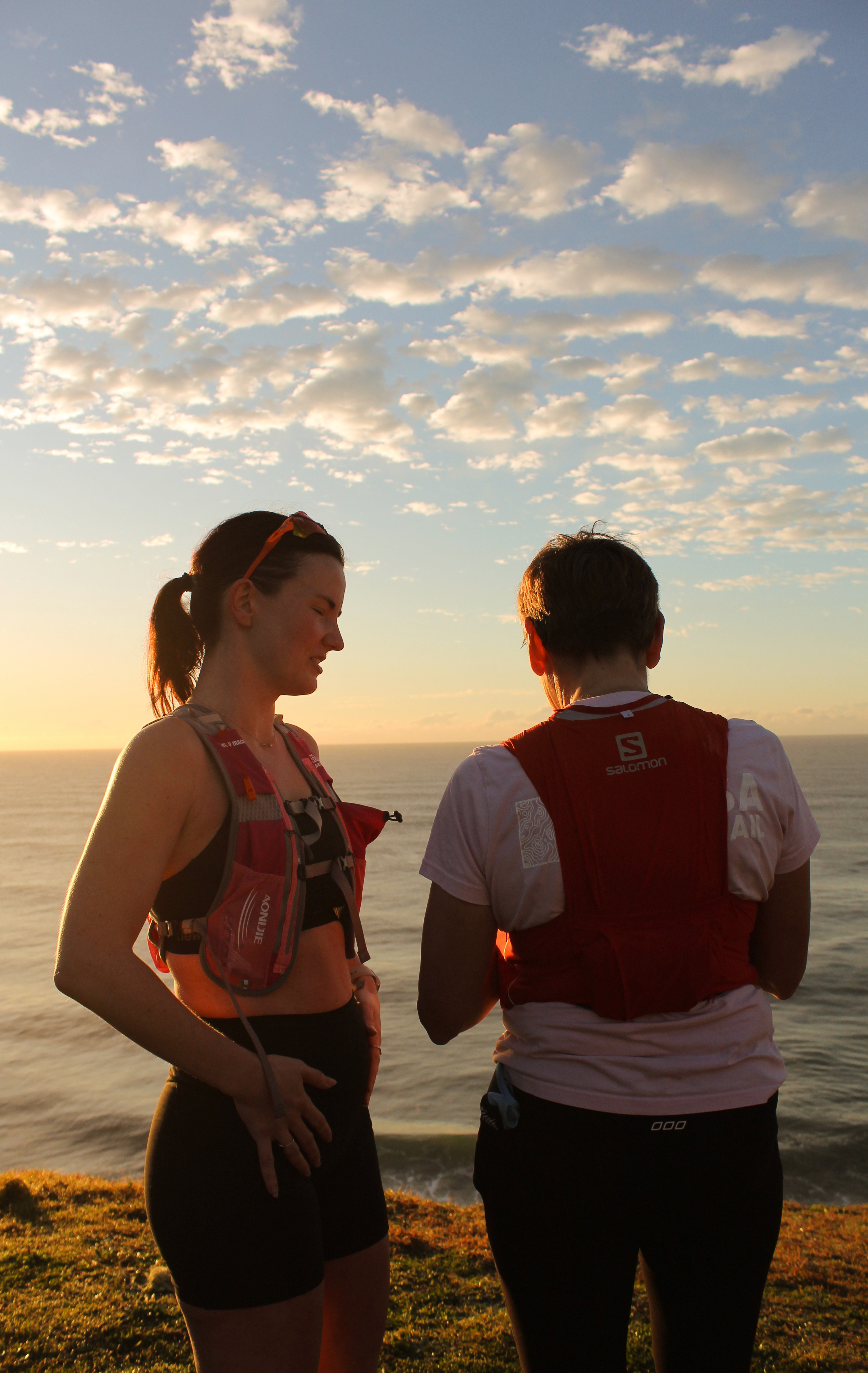 Two women on a Trail run watching the sunrise