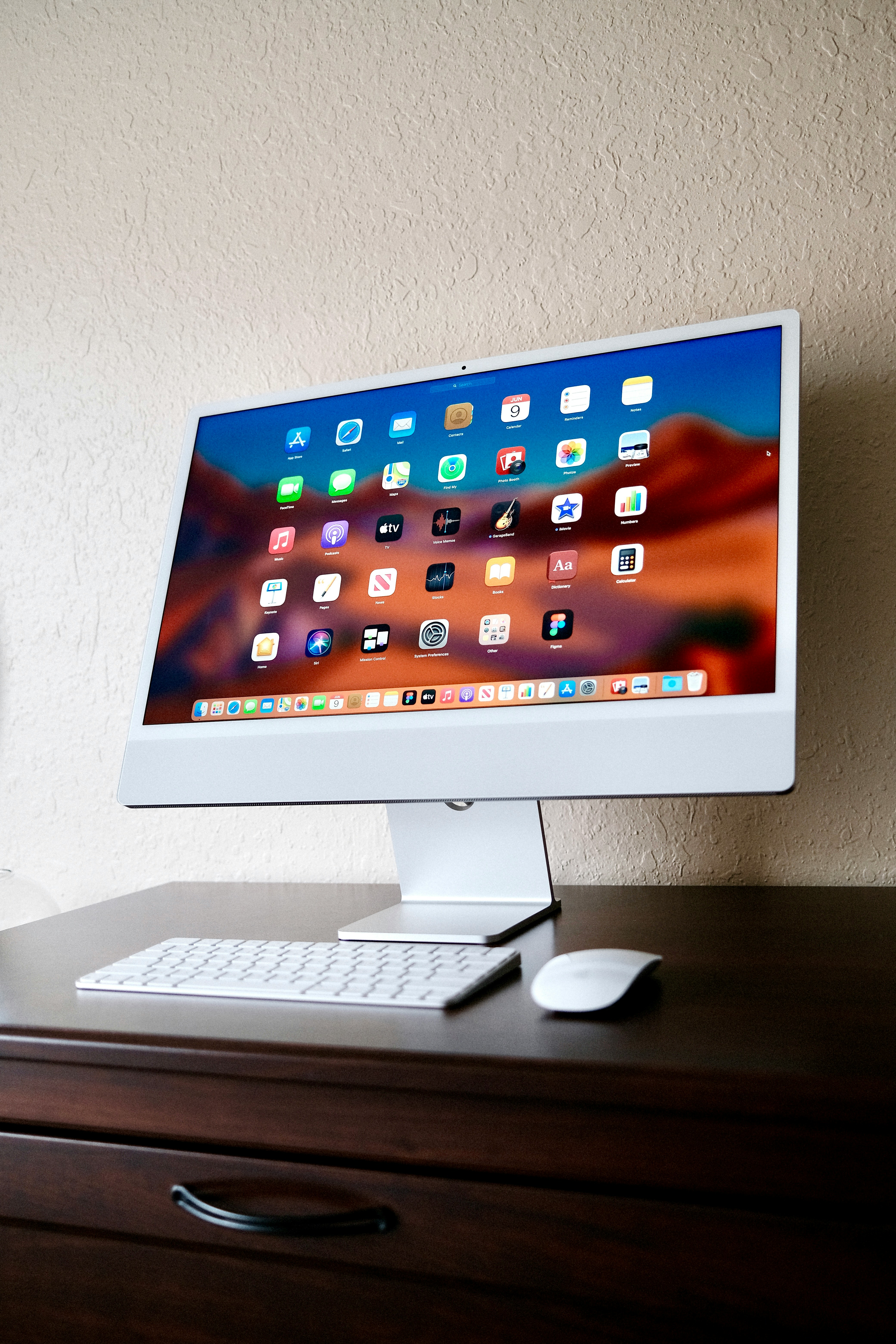 a desktop computer sitting on top of a wooden desk