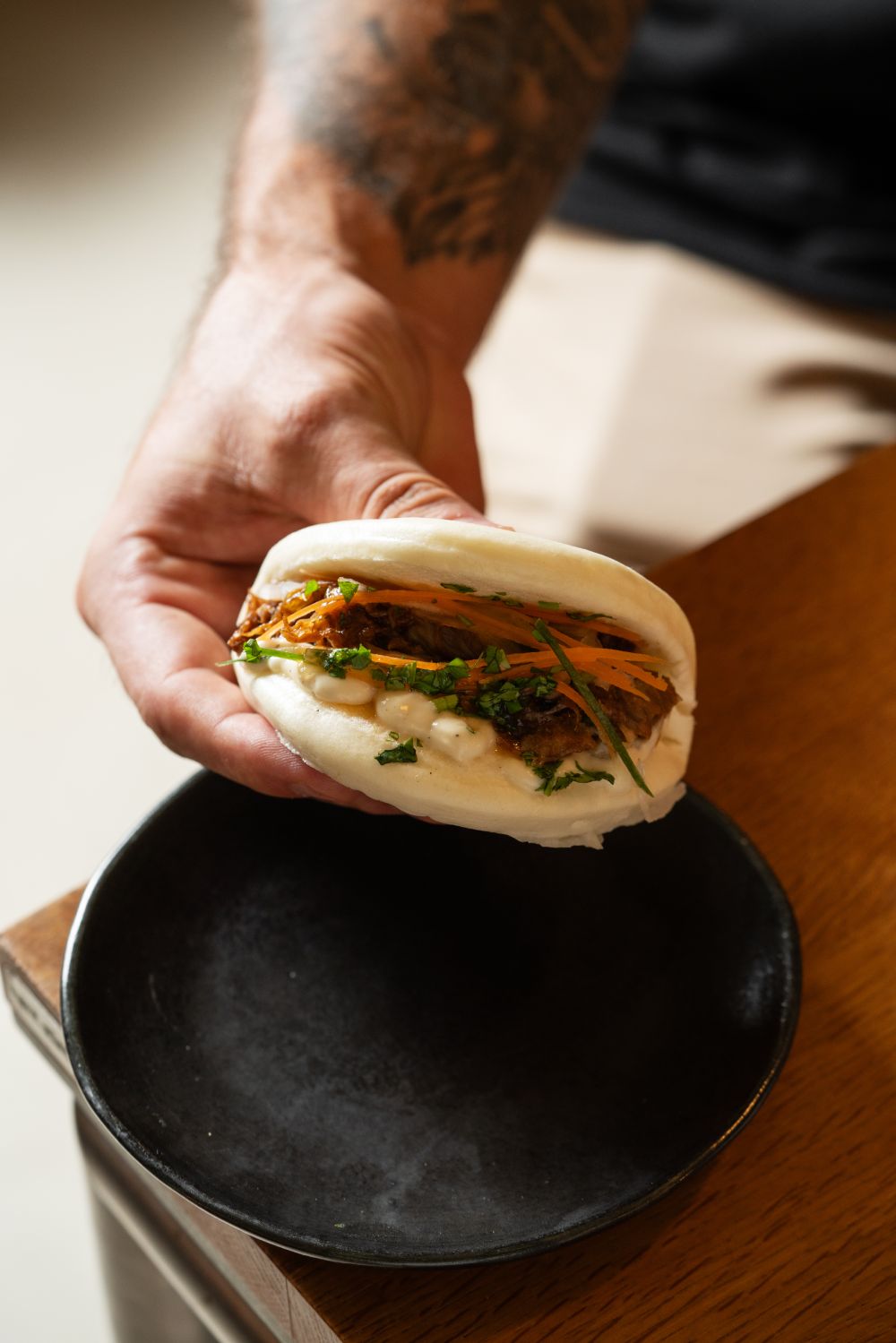 Vegetarian bao bun with pulled filling, pickled carrots and fresh herbs — tapas at Faire. Tapas & Wine, Eixample Barcelona