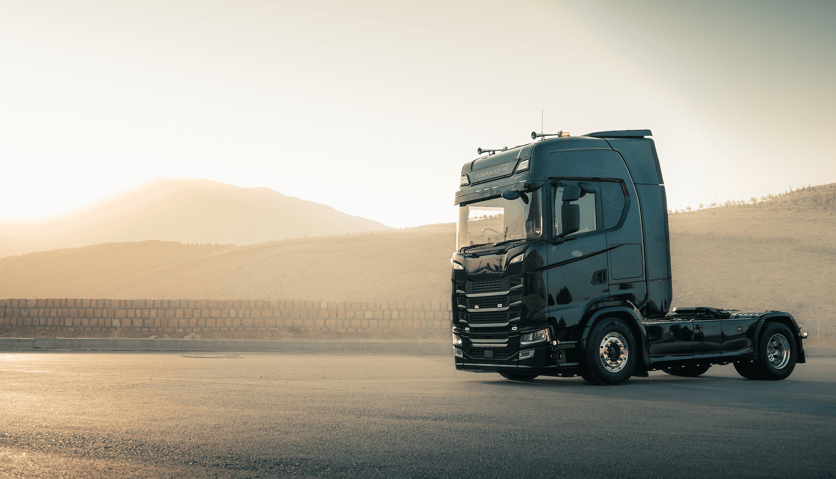 person sitting on grass and using phone