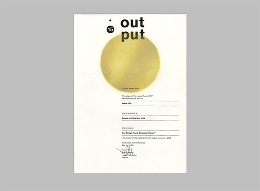 A piece of paper with a yellow ball printed on it, some text and a signature. The title for the paper is: Out Put 15.