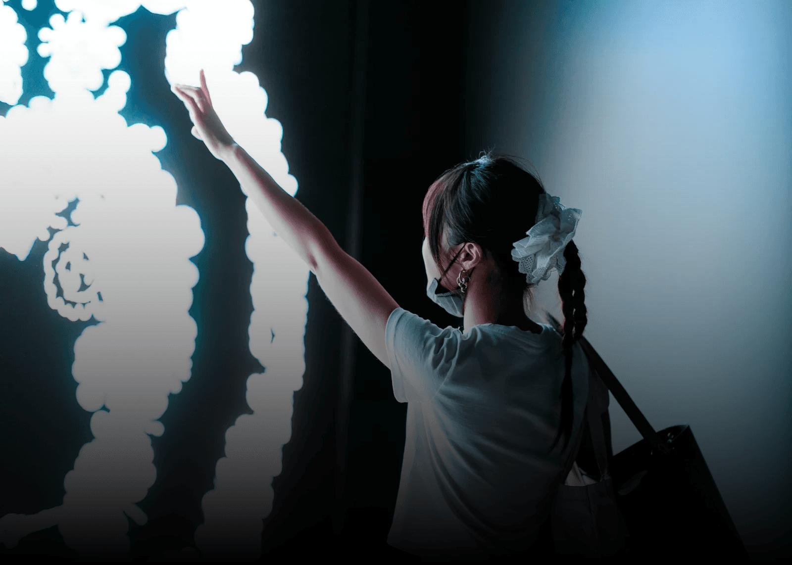 A guest interacting with the Vogue x Samsung Immersive Interactive Experience
