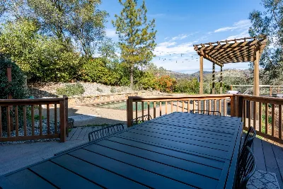 Outdoor deck dining table overlooking a pool