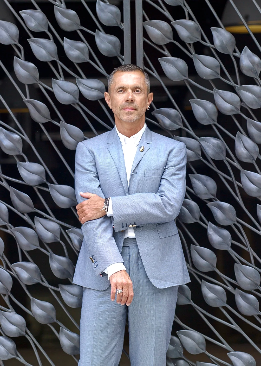 Artist Shaun Leane standing in front of his Arbour objet d'art, a large-scale architectural bronze sculpture featuring 1,850 hand-cast leaves.