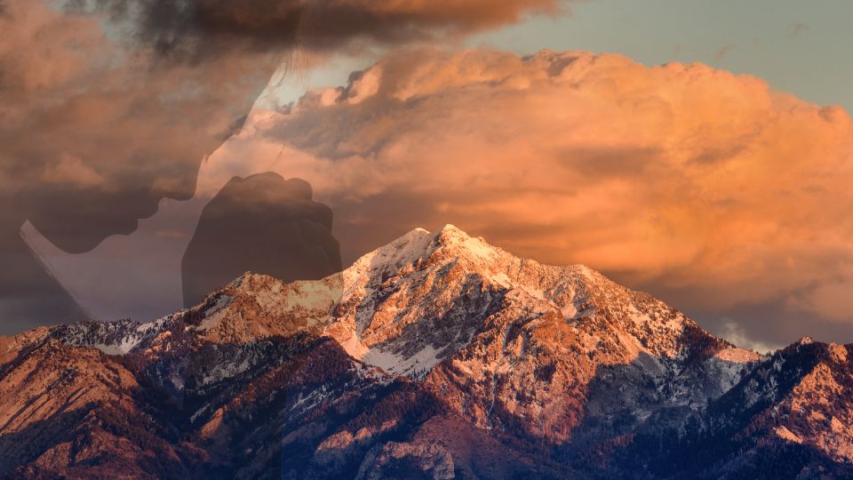 women prays with utah mountain in background