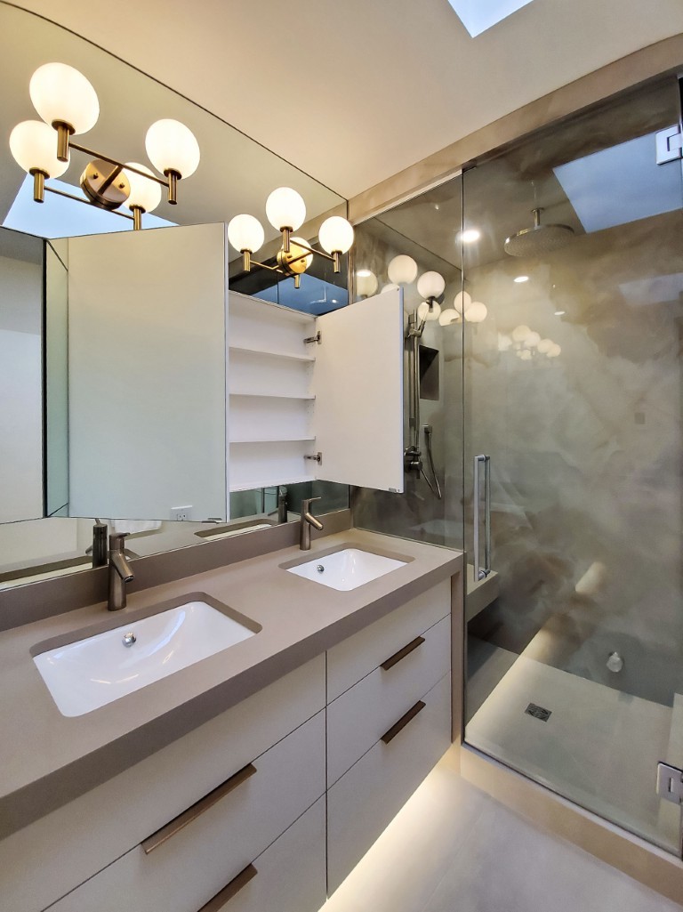 Image of Modern KHD Homes bathroom design with dual sinks, large mirror, and luxurious spa-inspired shower and cabinetry.