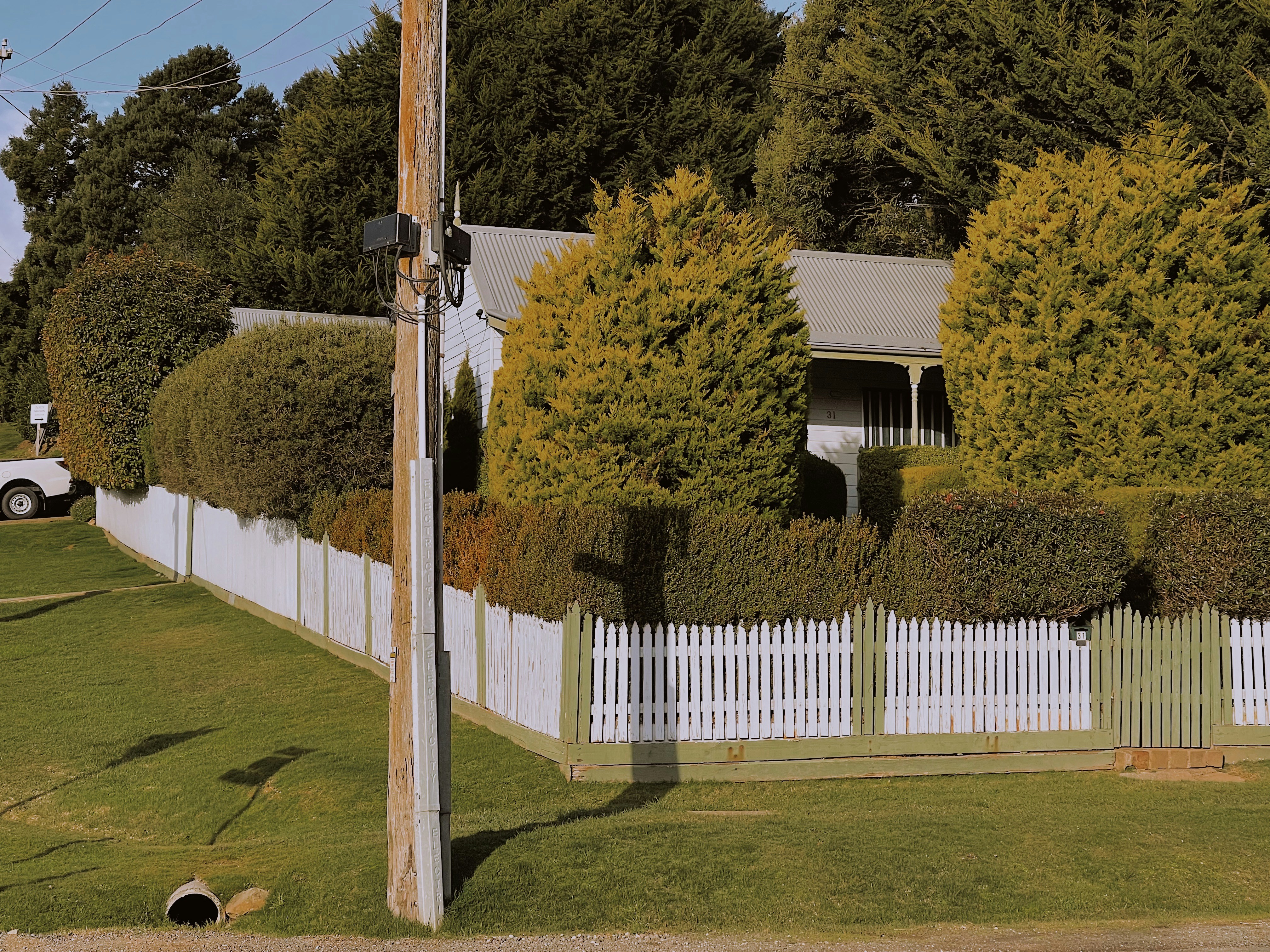 a white picket fence in front of a house