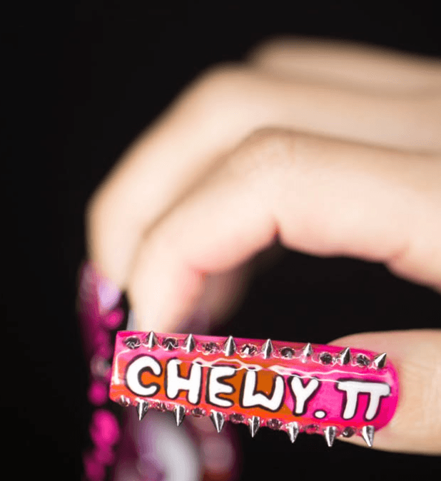 Close up image of nails with phrase "CHEW IT"