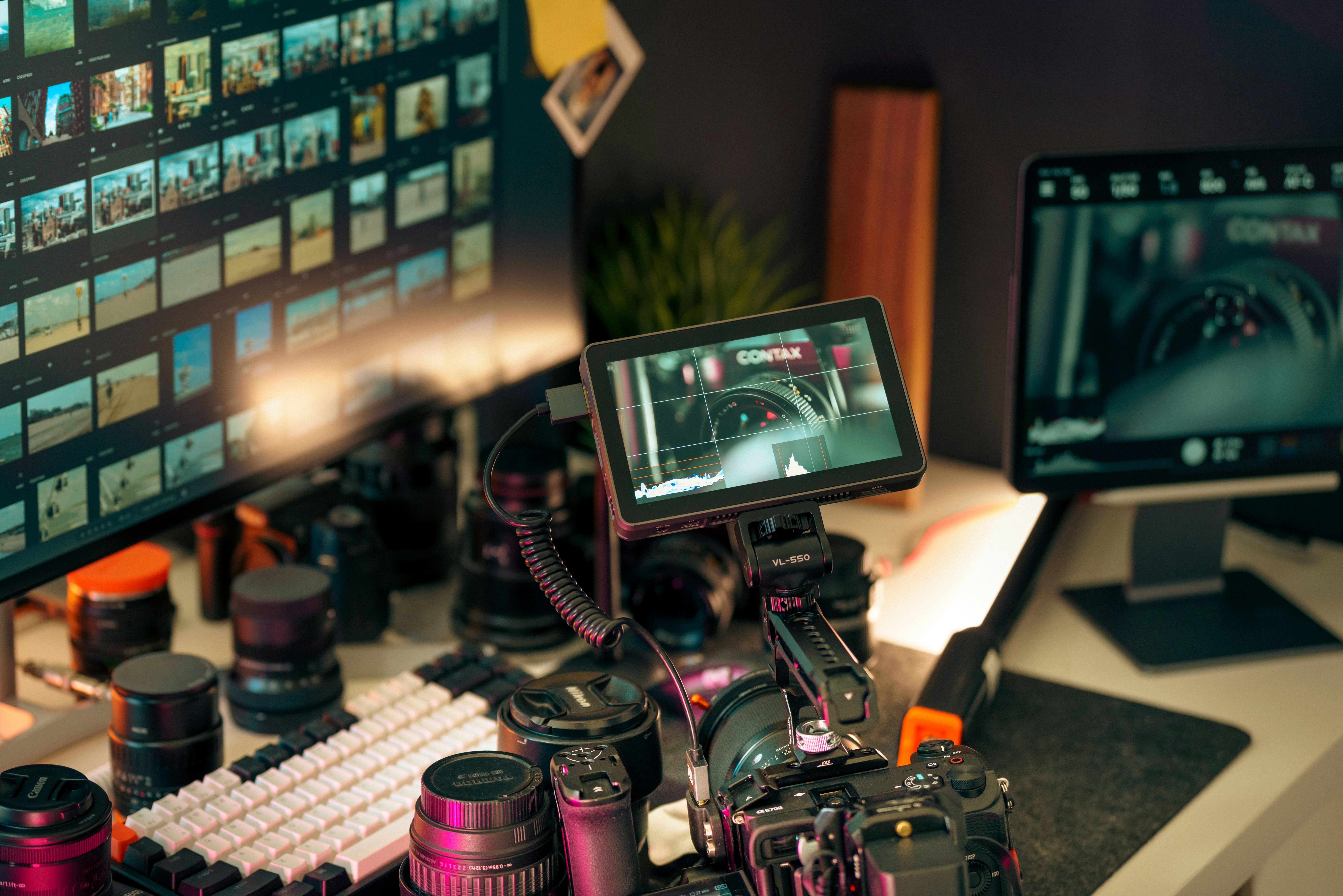 Filmmaker's setup with cameras, lenses, and monitors