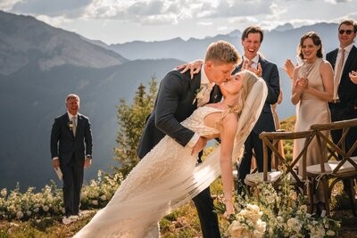 Tucker dips Clemmie for a kiss at the end of the aisle as guests applaud.