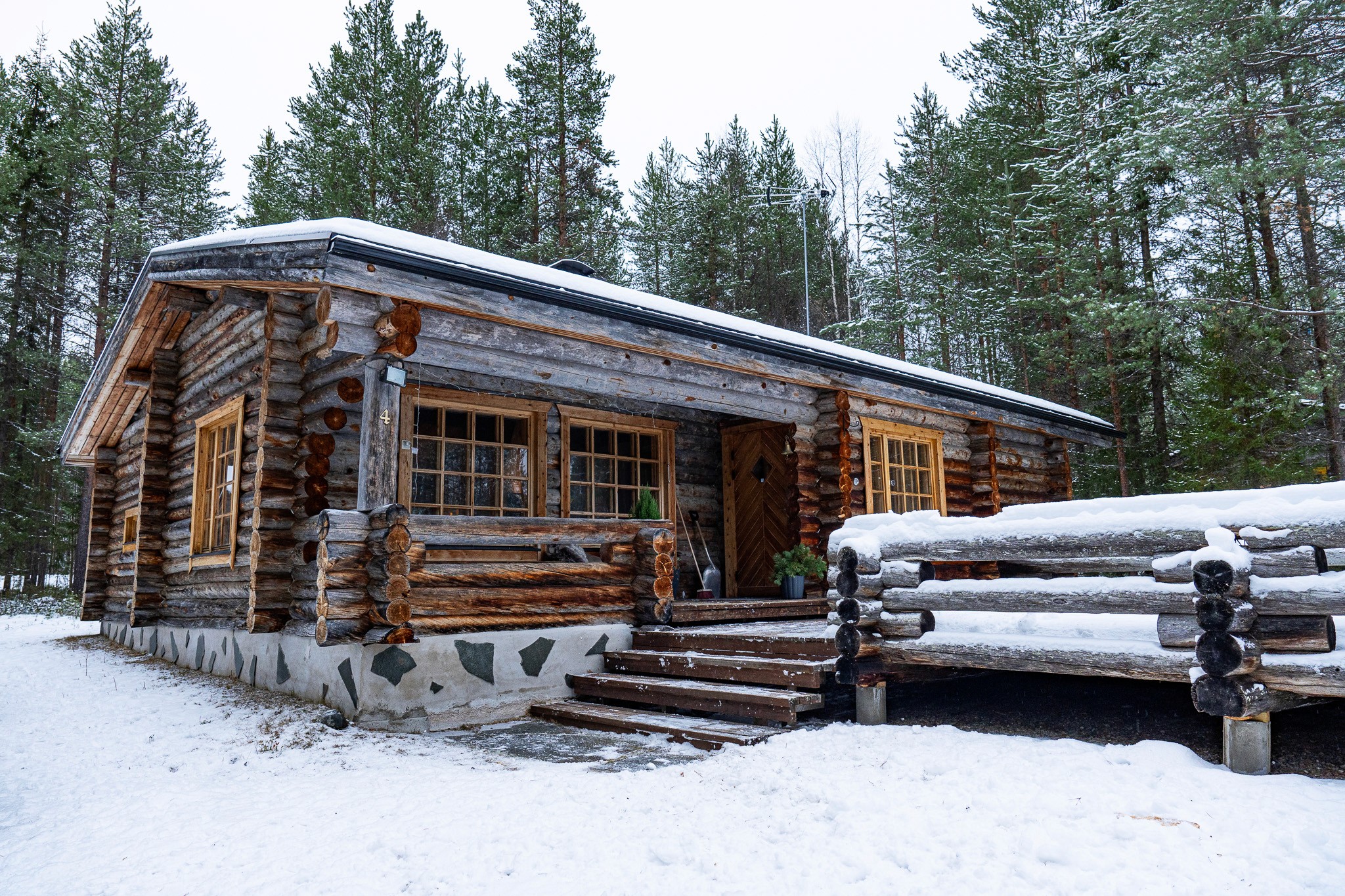two people in a workspace working on their laptops