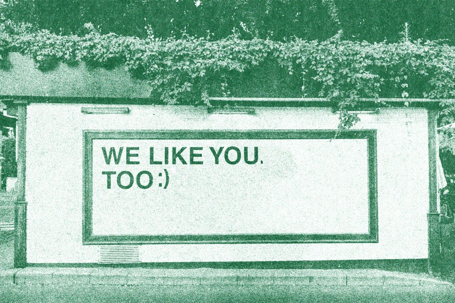 green wall with a we like you too text with a smiley face