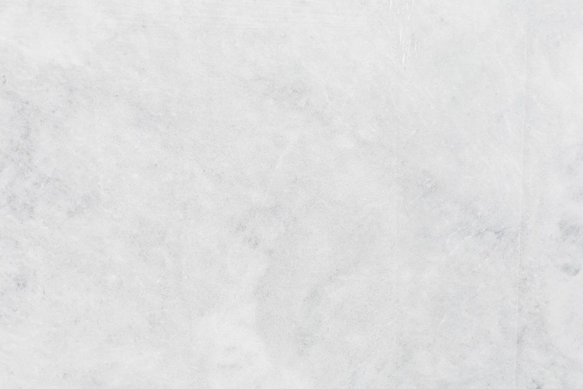 A close-up of Greek Crystal marble, showcasing its sparkling and crystalline white texture.