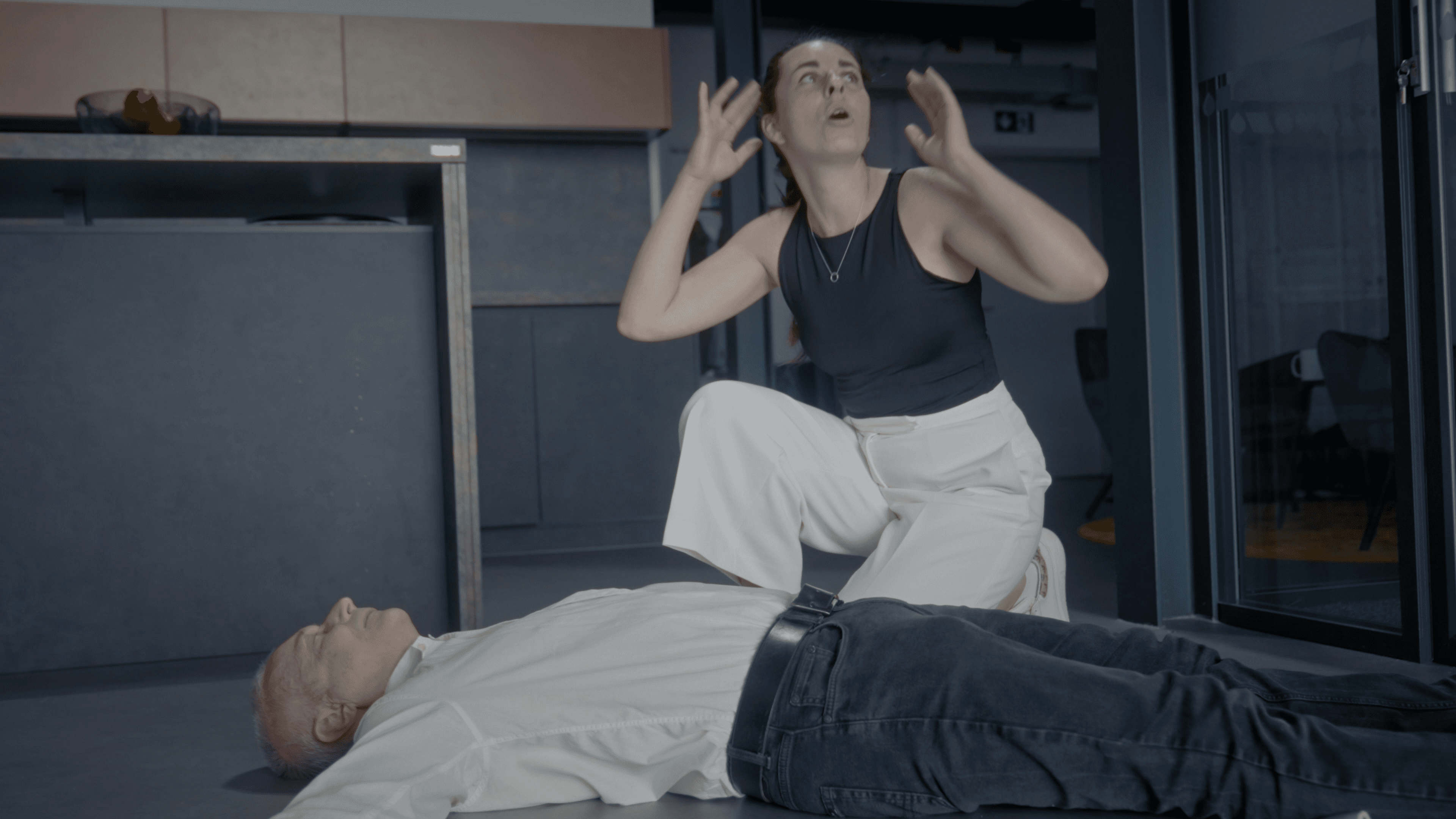 two people looking at a tablet and smiling