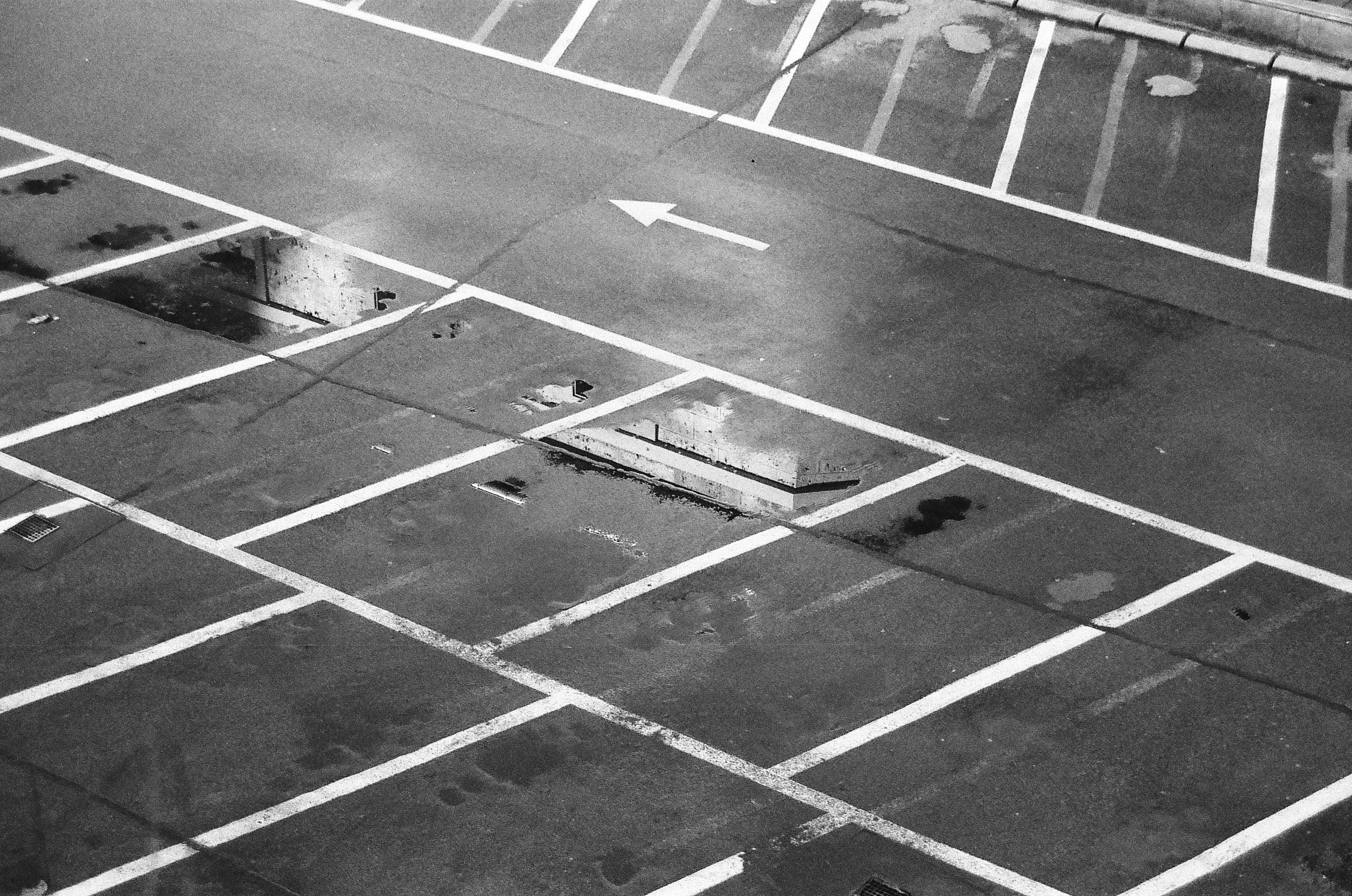 a black and white photo of a parking lot
