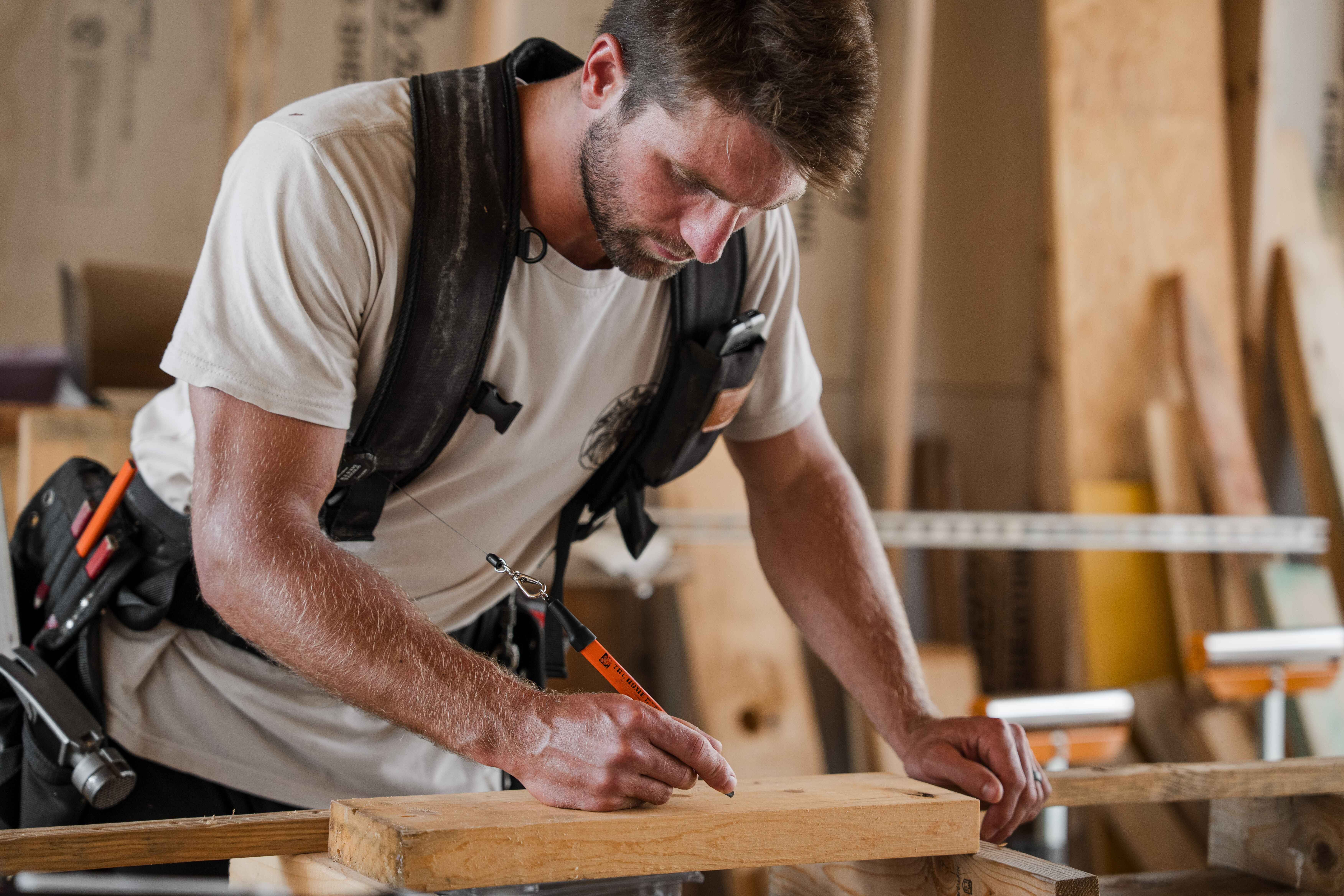 Black and white image of people working at a table with laptops, showing hands gesturing during discussion of digital content displayed on screens, with fabrica® logo in the corner.