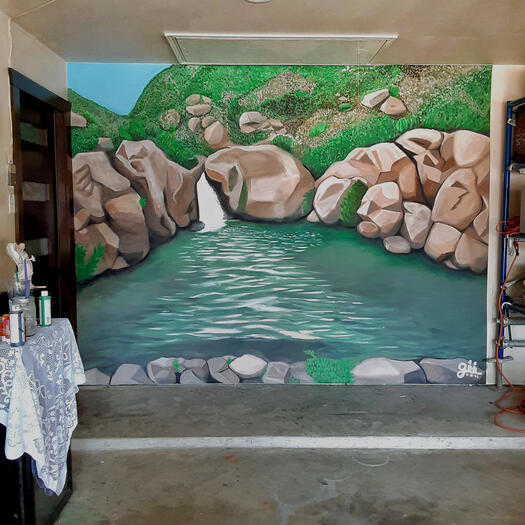 A mural about a hidden oasis between mountains.