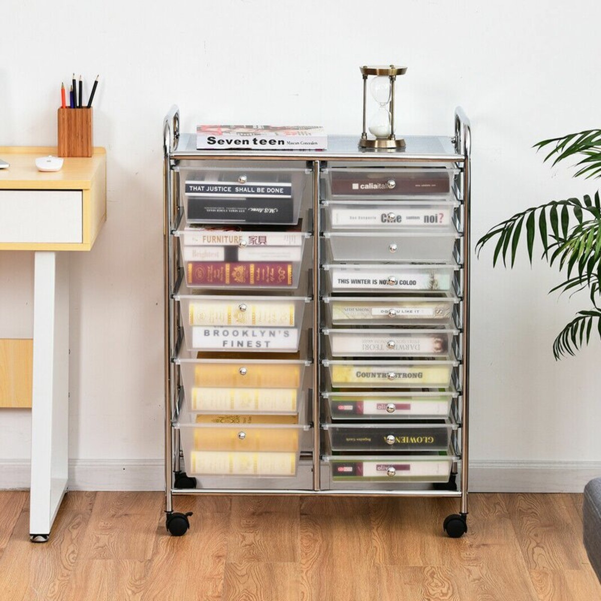 Rolling Organizing cart for extra storage against a white wall with books in the drawers.