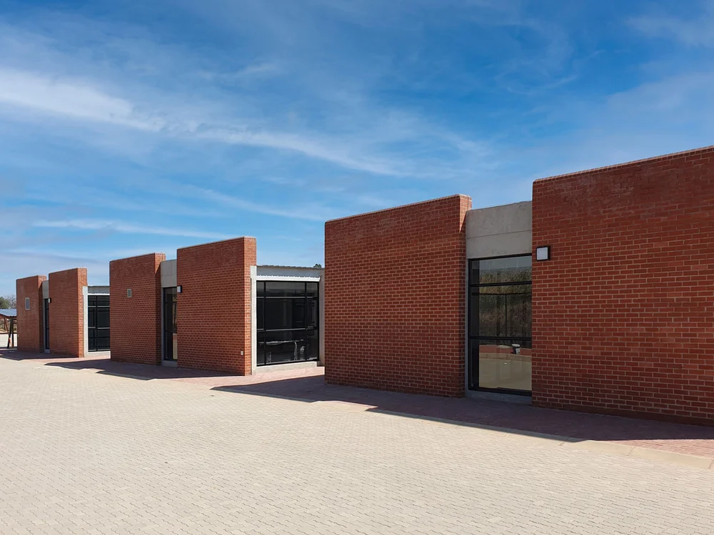 Woman’s face framed by soft white fabric with intense gaze.