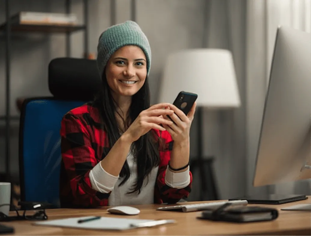 A woman sitting at desk on a phone