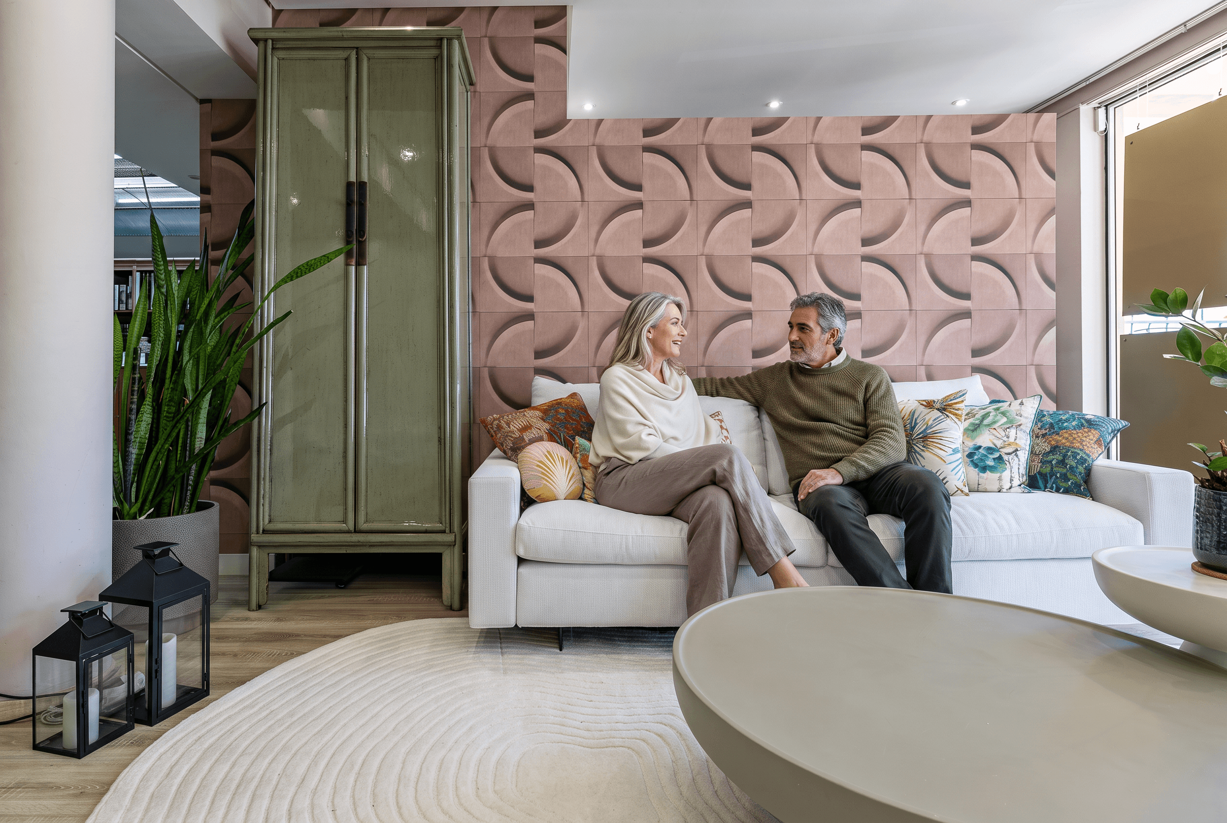 Two people on a cream sofa in our showroom. The people were added with AI.