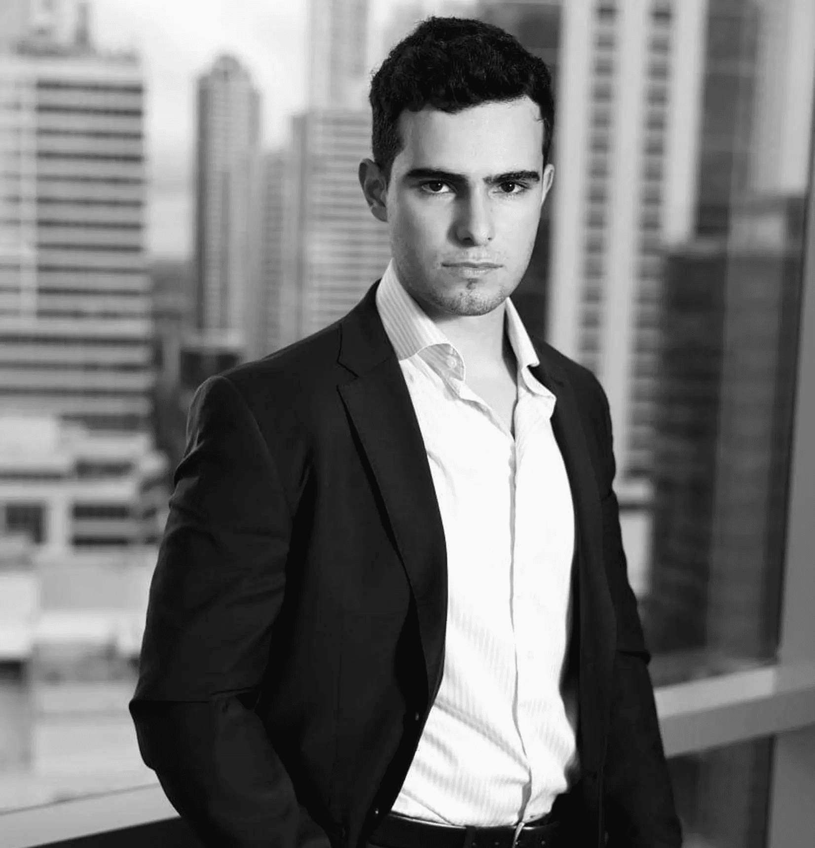 A man works on a laptop in an office.