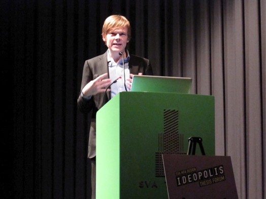 a man in suit giving a speech