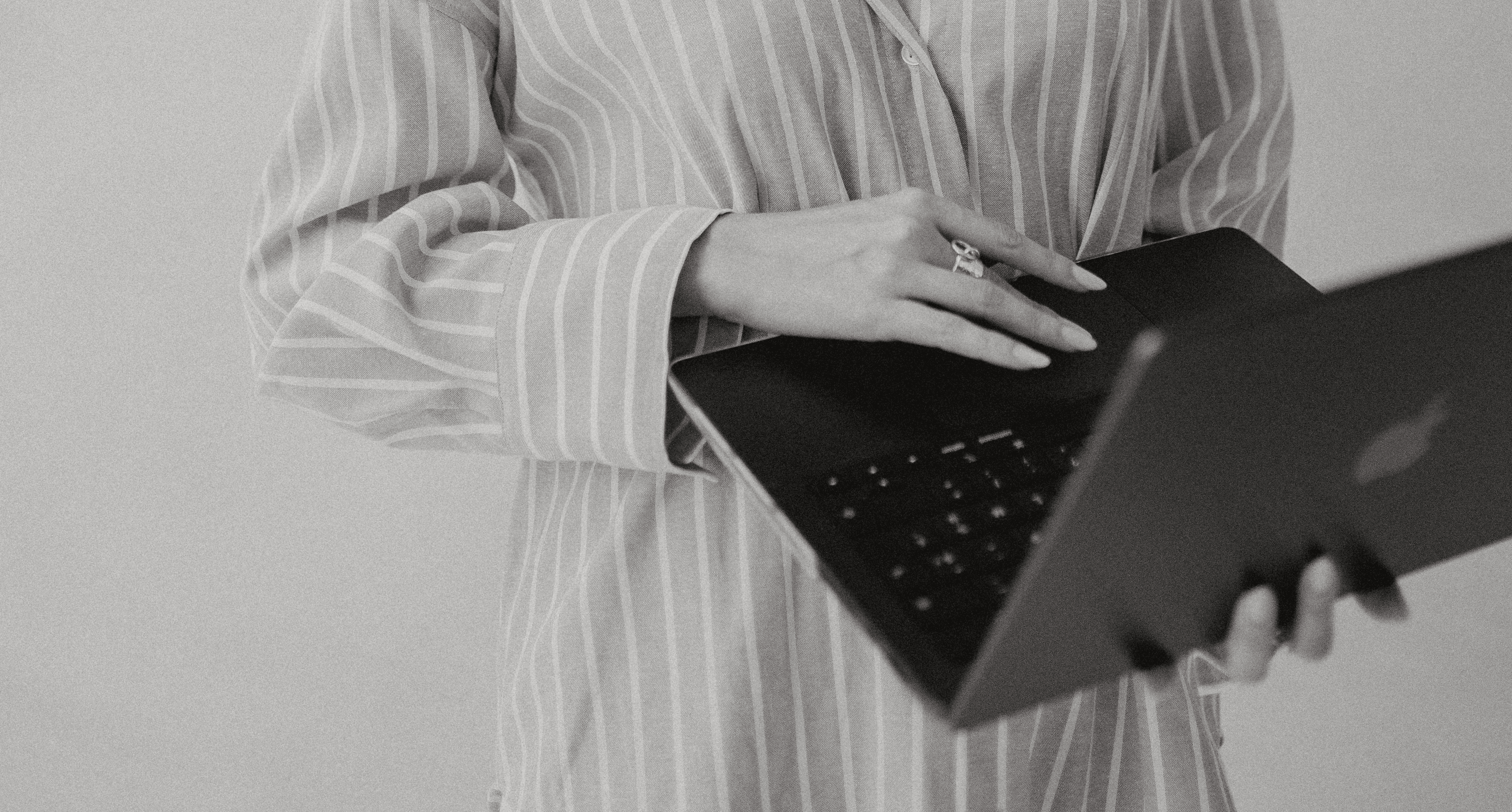 A close-up of a beige-colored laptop with a smooth, matte finish on a matching surface.