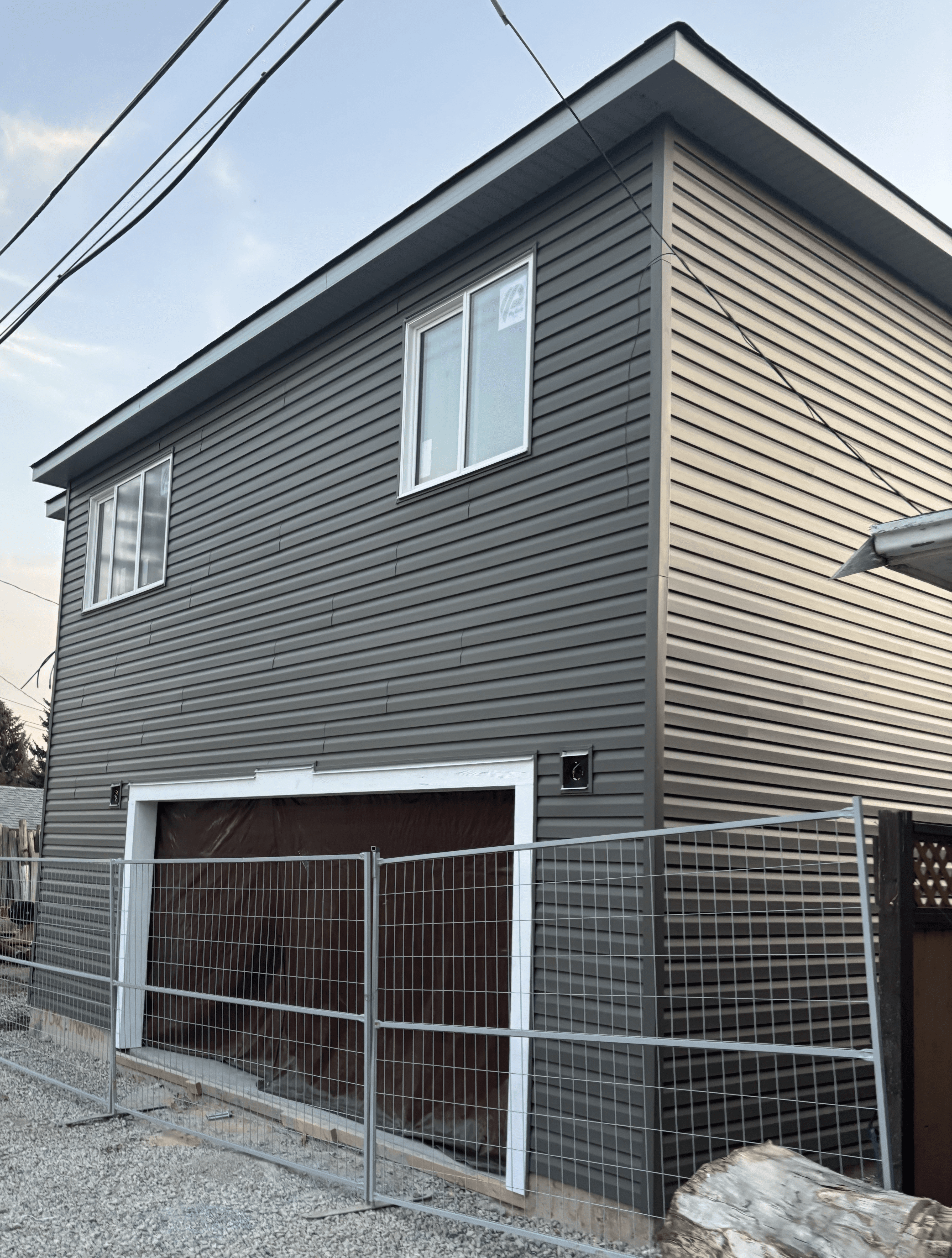 Service wall detail with conduits and corner trims against vinyl siding