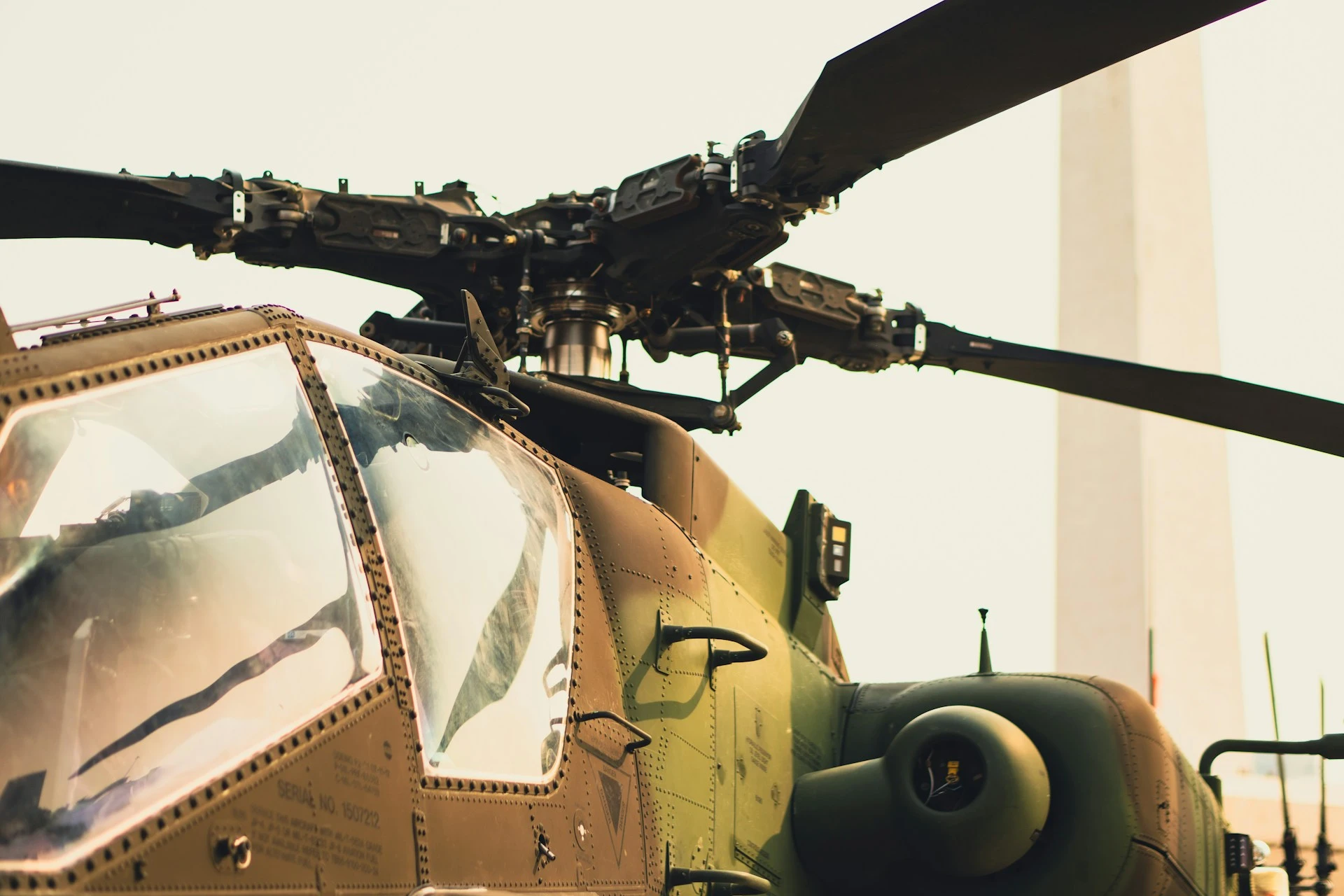 Close view of a military helicopter rotor head and cockpit