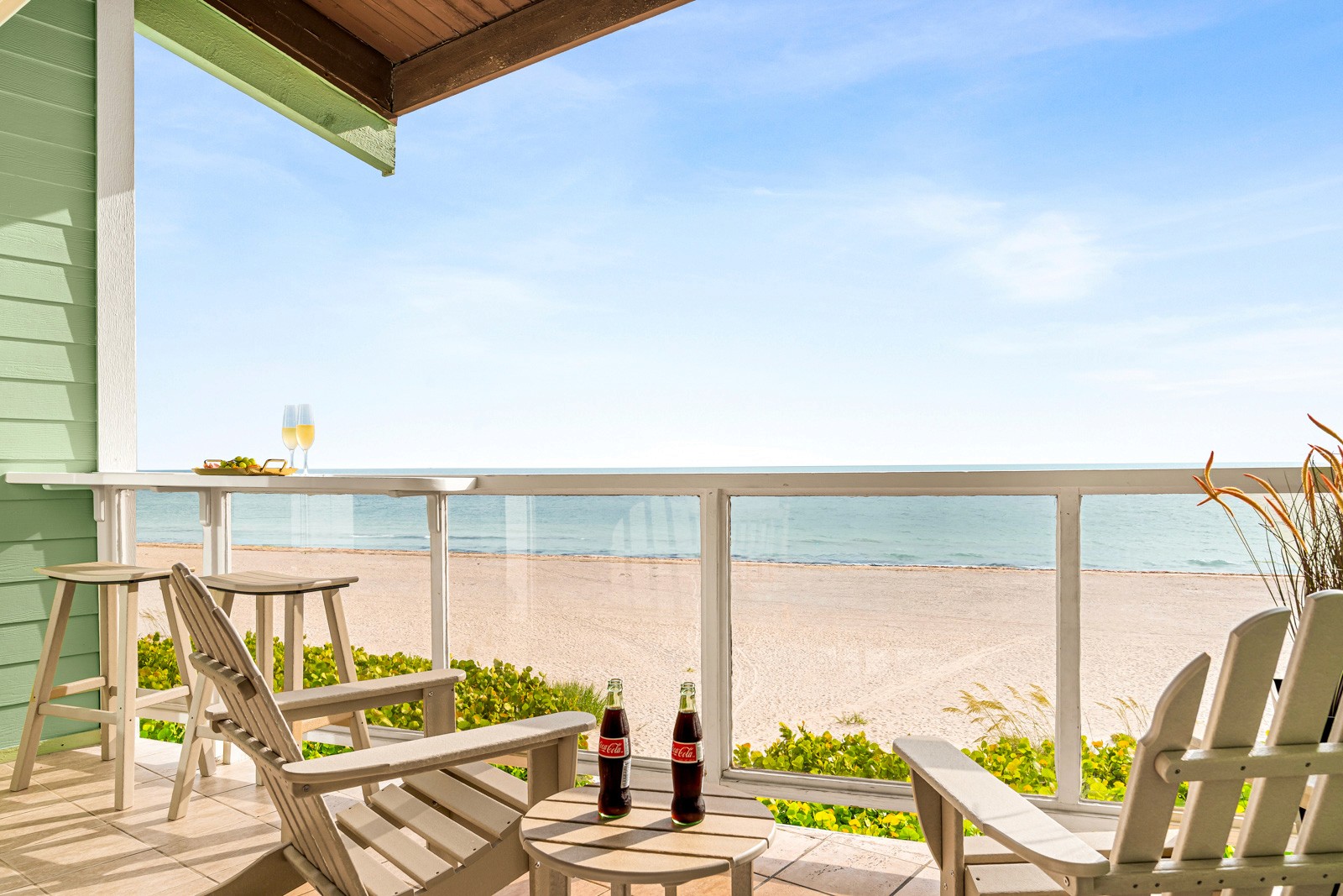 Beachfront rental balcony with Adirondack chairs and a view over the Gulf of Mexico, from our Indian Shores Airbnb shoot