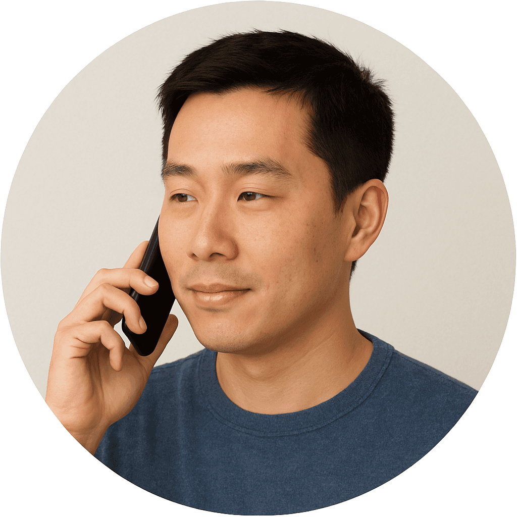 Man holding a phone to his ear, neutral background