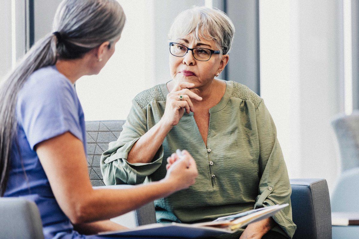 man sitting beside woman looking at a contract on DocuSign